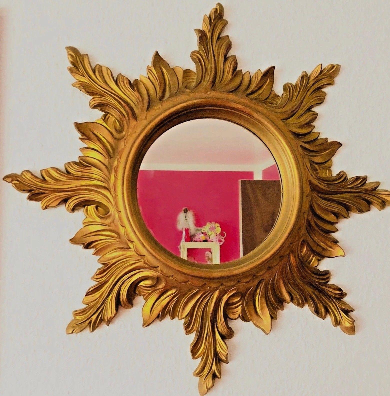 A gorgeous starburst mirror. Made of plastic or resin. No chips, no cracks, no repairs. It measures approximate 19 3/4
