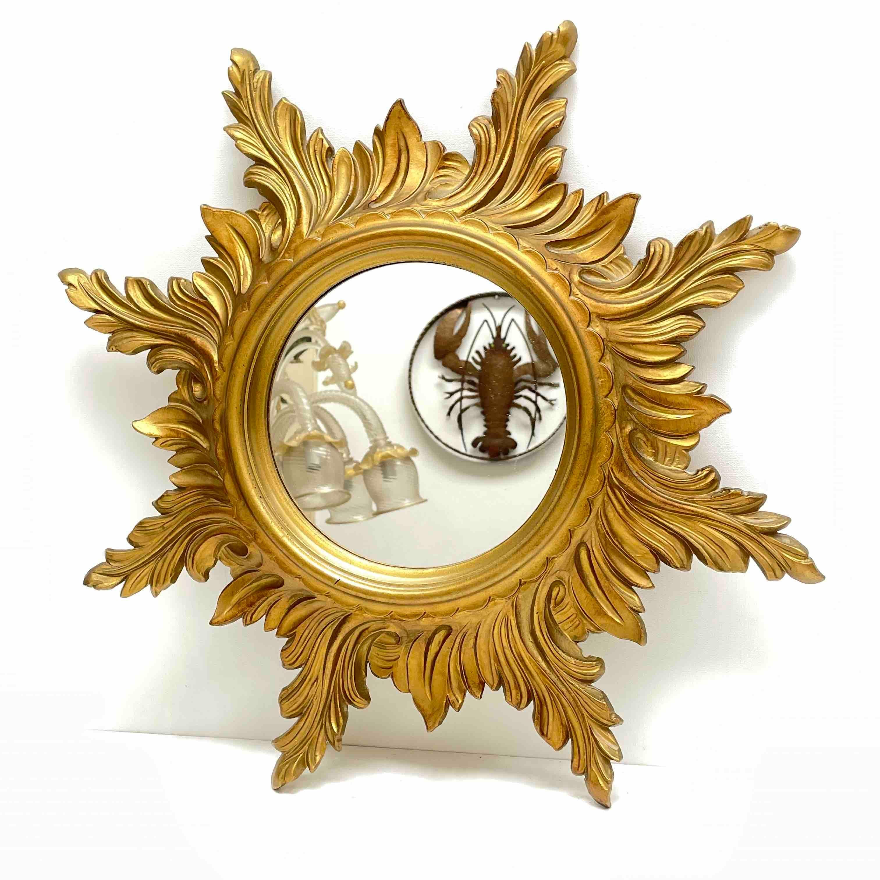 A gorgeous starburst mirror. Made of resin. No chips, no cracks, no repairs. It measures approximate 19.25