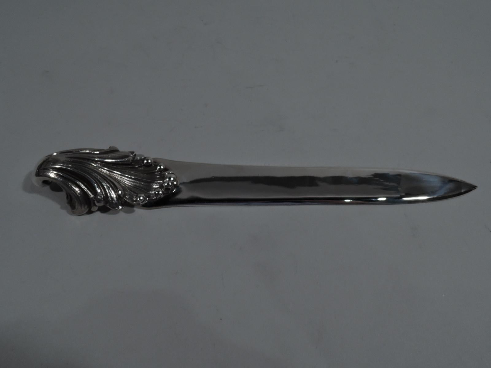 Beautiful sterling silver letter opener. Made by Mario Buccellati in Milan. Plain tapering blade and applied handle in form of fluid and dynamic leafy shell. A marvelous return-to-paper desk accessory. Italian hallmark (1944-1968) including maker’s