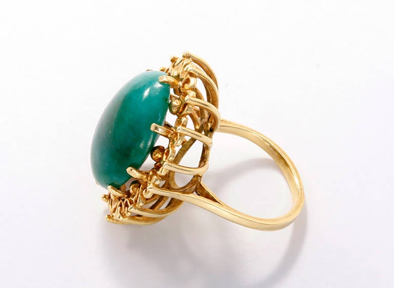 This is a beautiful ring featuring an oval jade cabochon measuring apx.  20.11 x 15.02 x 9.44 mm. The ring is a size 5.75 and weighs 9.6 grams.  This ring makes a beautiful statement piece.