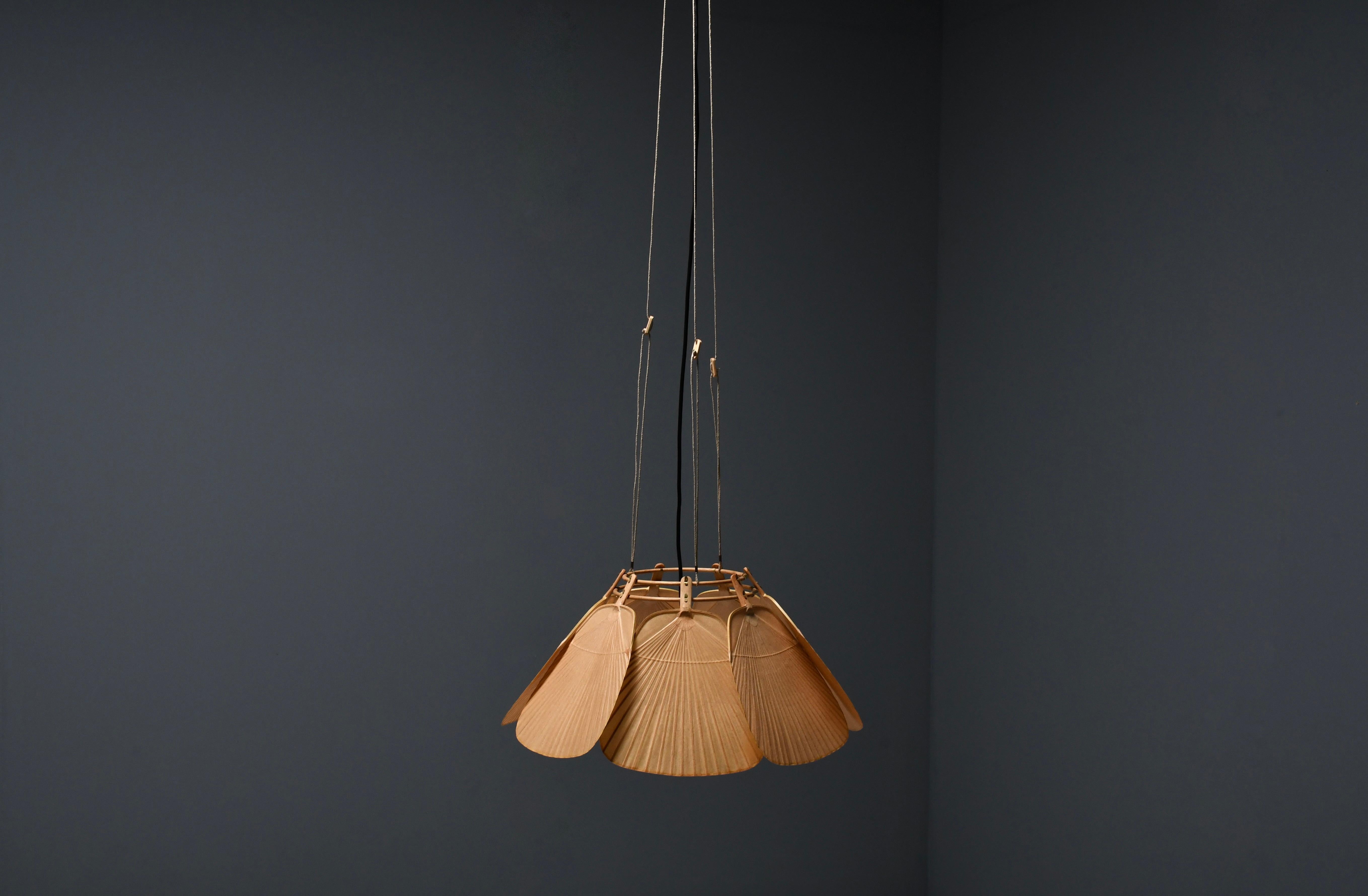 Rare Uchiwa Ju-Yon chandelier in very good condition. 

Designed by Ingo Maurer for M design, Germany. 

This chandelier is handmade from bamboo and Japanese rice paper. 

The lamp consists of seven fans hanging from a bamboo frame. 

When lit the