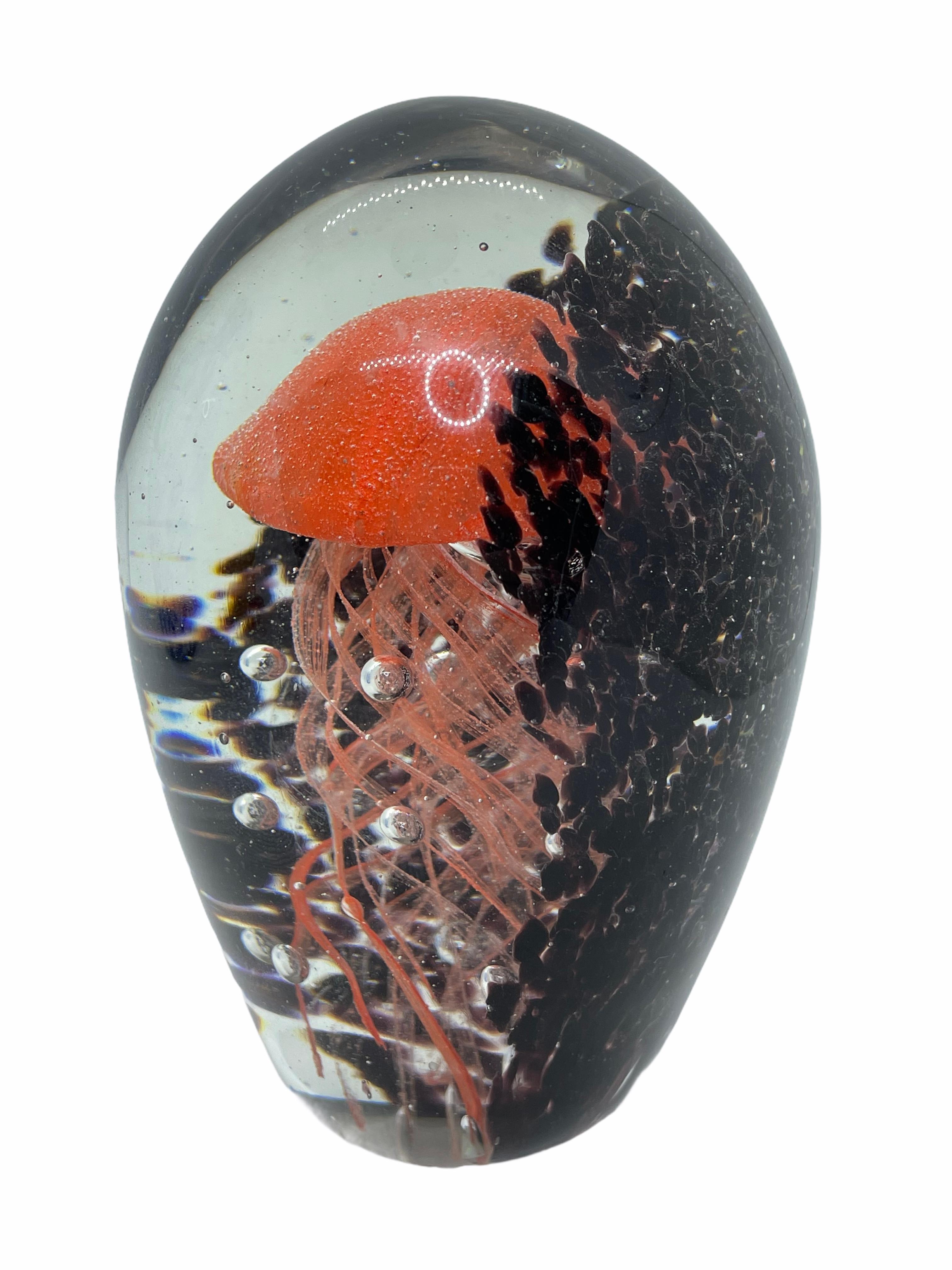 Beautiful Murano hand blown aquarium Italian art glass paper weight. Showing a jelly fish, underwater floating on controlled bubbles. Colors are a black, orange and clear. A beautiful nice addition to your desktop or as a decorative piece in every