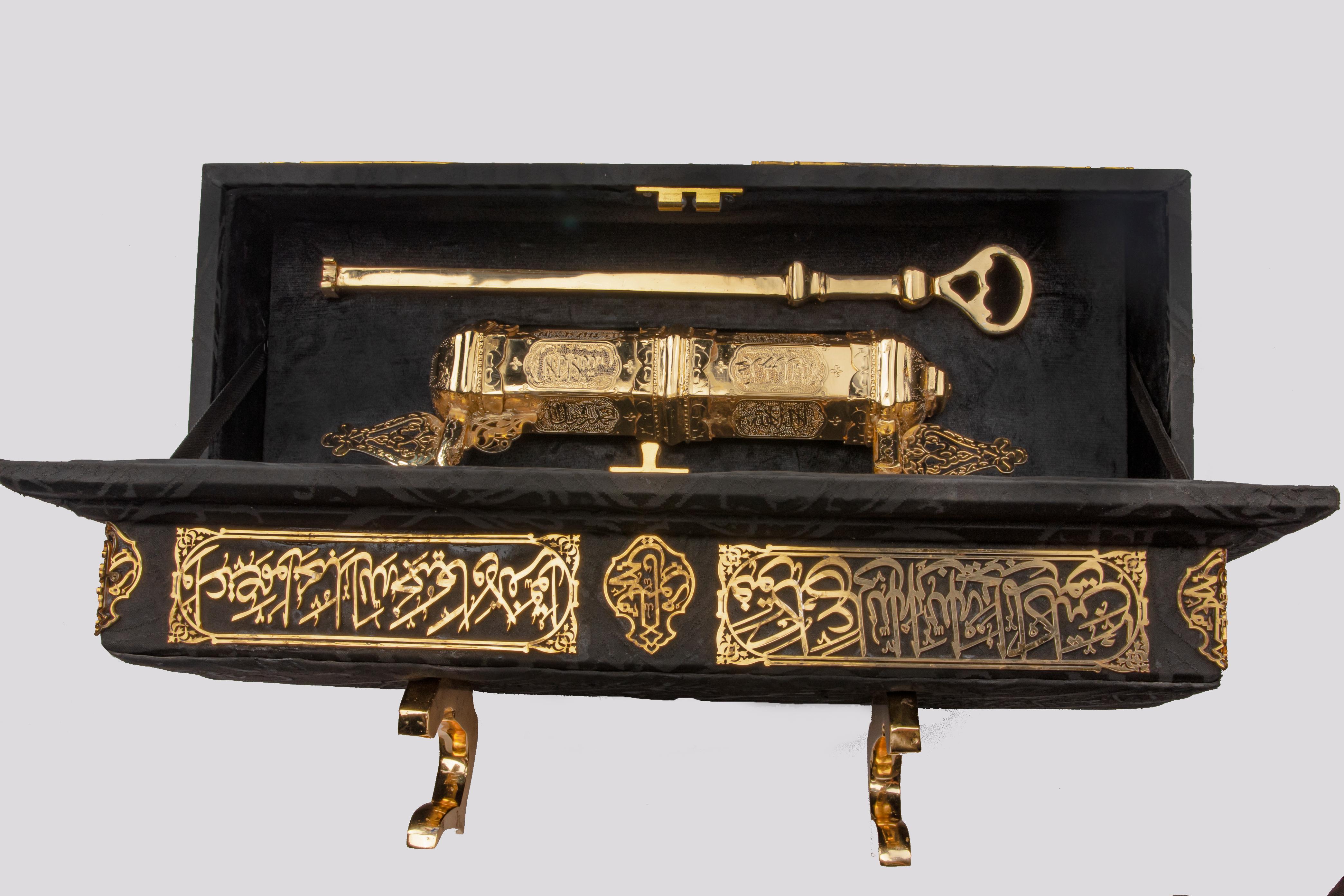 A replica of the key and lock of the Holy Kaaba during the reign of Sultan Ibrahim - made of yellow and red copper coated with a layer of pure gold - placed inside a box decorated with copper strips from the corners with Islamic inscriptions plated