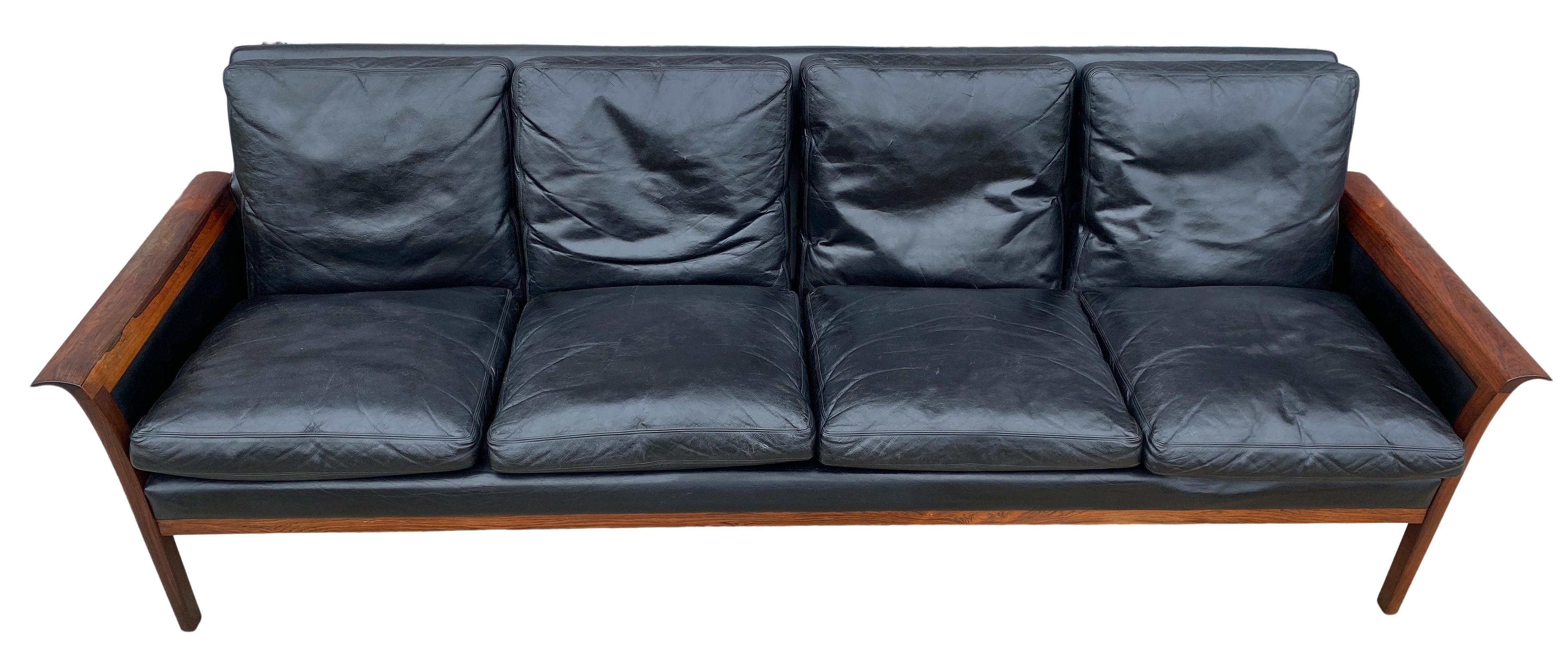 Beautiful Knut Saeter for Vatne Mobler black leather and rosewood four-seat sofa couch. All original Black leather upholstery worn in nicely. Stunning rosewood curved arms and legs. Very solid long 4 seat black leather sofa. Labeled - Vatne Mobler.
