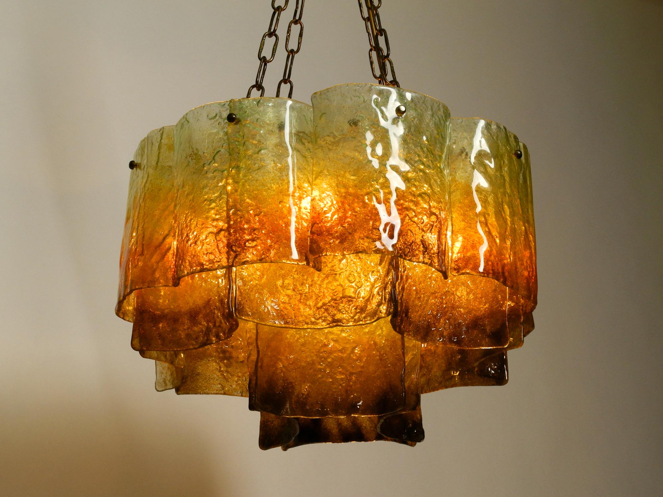 Beautiful large 1960s Italian Murano glass chandelier.
20 large curved Murano glasses color changing from red-brown to light green. 
Very high-quality stunning ceiling lamp for great, charming light in every room.
Frame and chains completely made