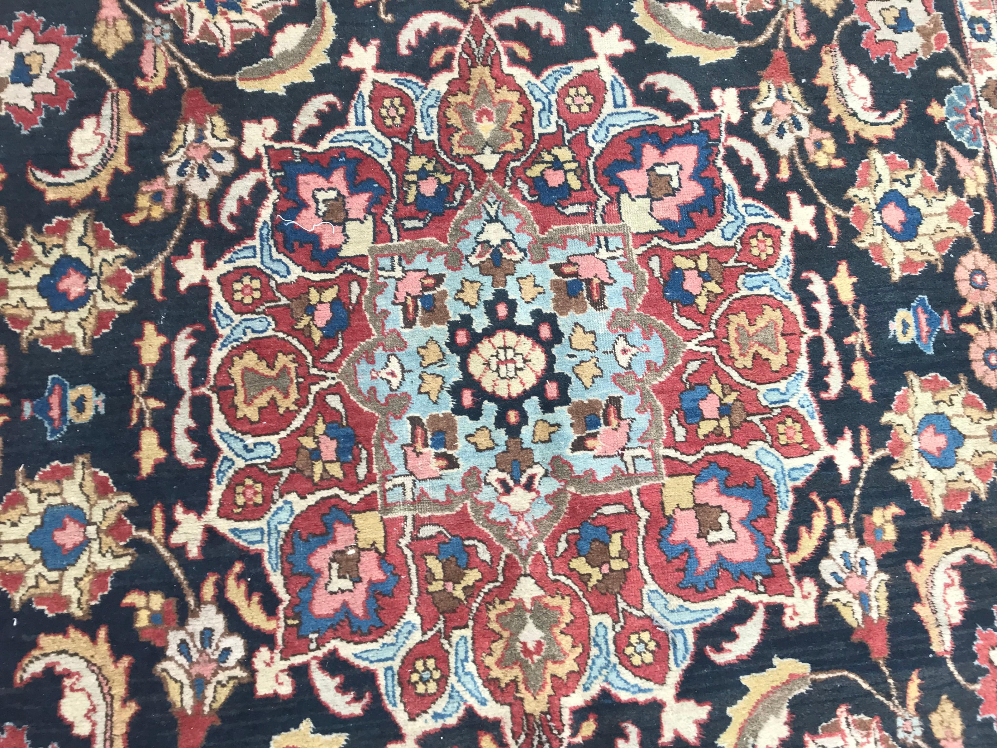 Beautiful early 20th century rug with decorative floral design and a central medallion, and natural colors with red, blue, yellow, green, pink, entirely hand knotted with wool velvet on cotton foundation.