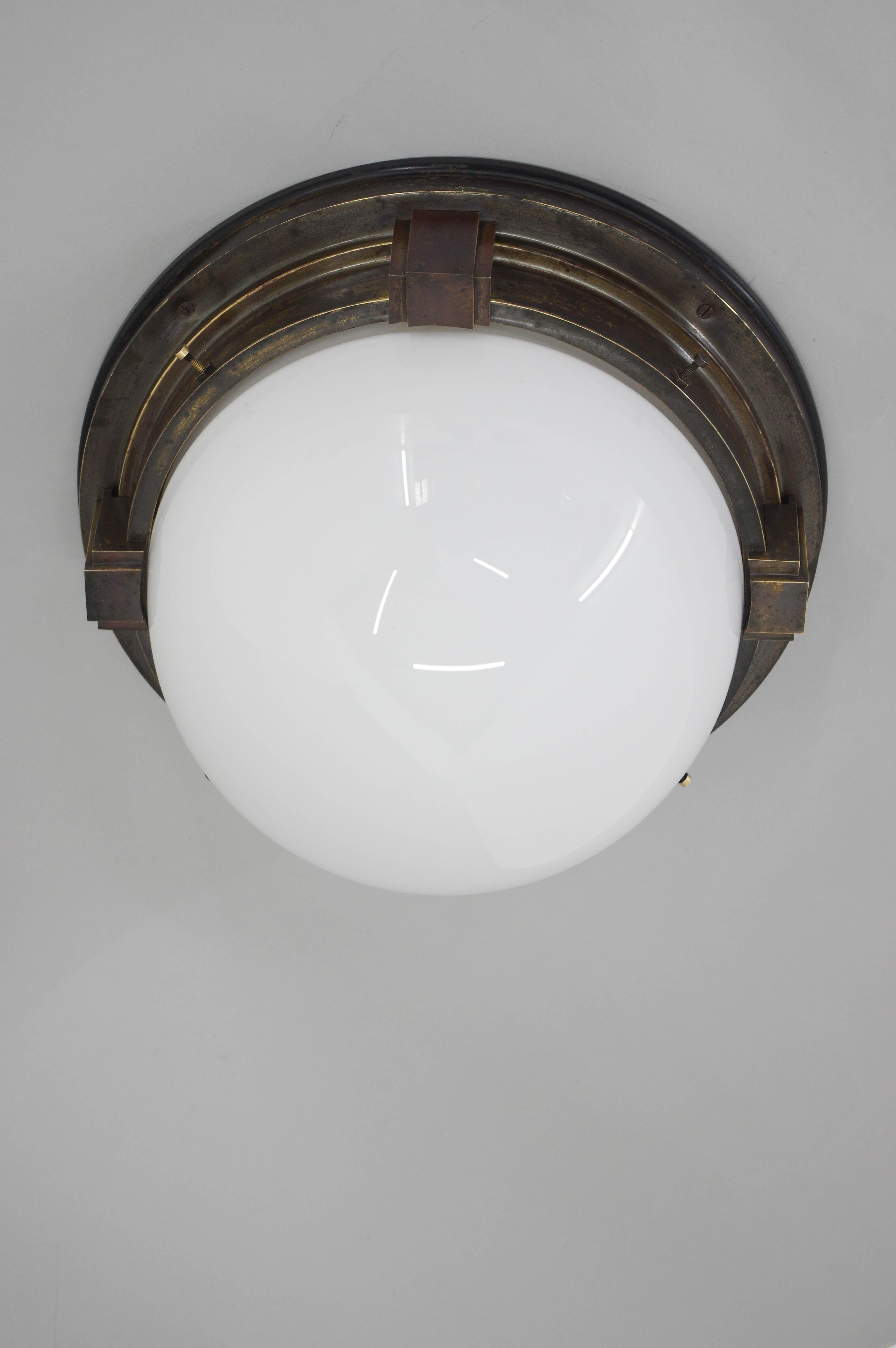Big Art Deco flush mount made in 1910s.
Wooden and brass base with beautiful patina.
Opaline blown glass shade without any damage.
Cleaned, polished and rewired:
4x60W, E25-E27 bulbs
US wiring compatible