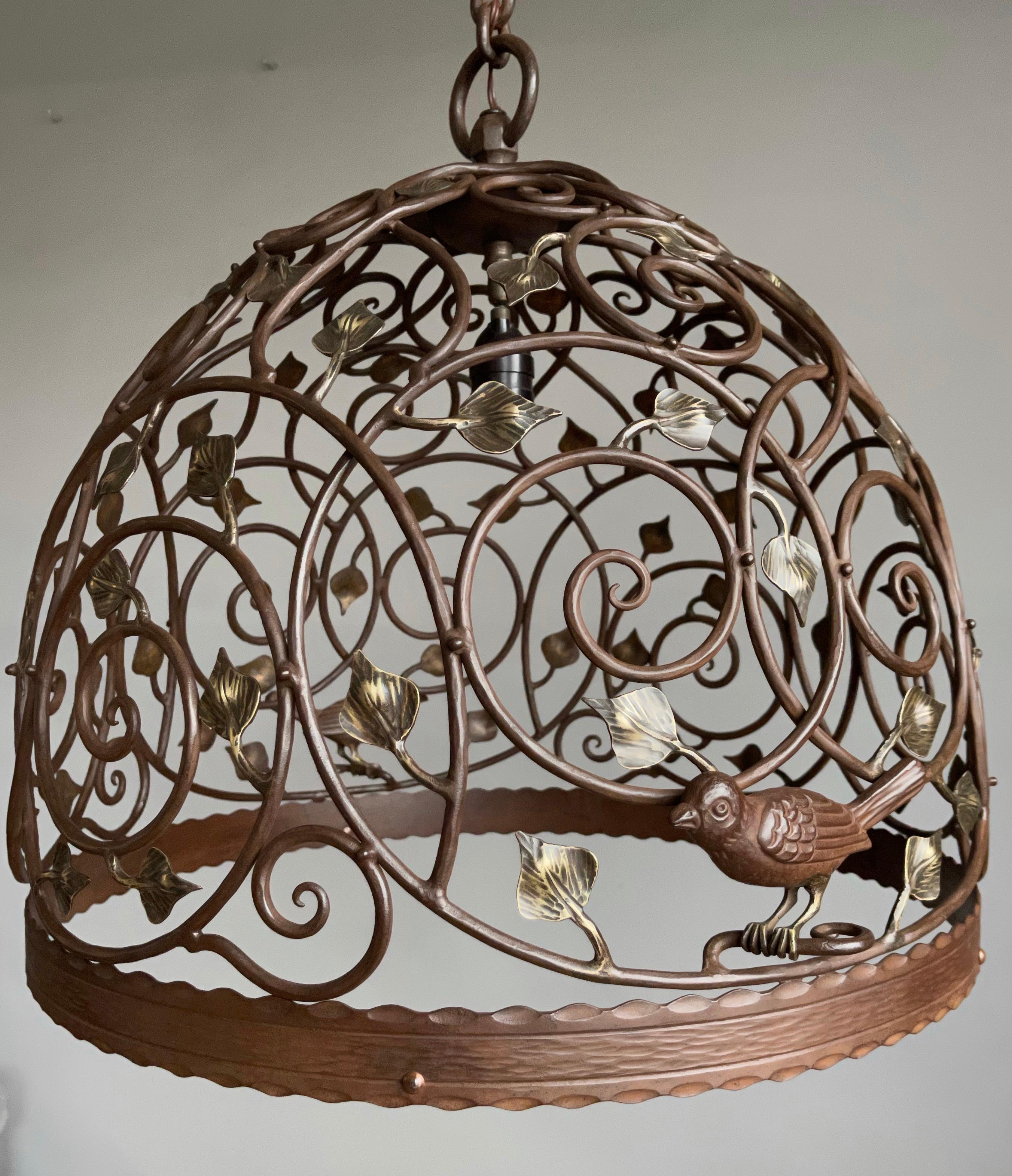 One of a kind and great looking antique pendant with decor of birds, branches and leaves. 

This great looking and all handcrafted wrought iron and bronze chandelier is another one of our recent great finds. The handcrafted swallow-like bird