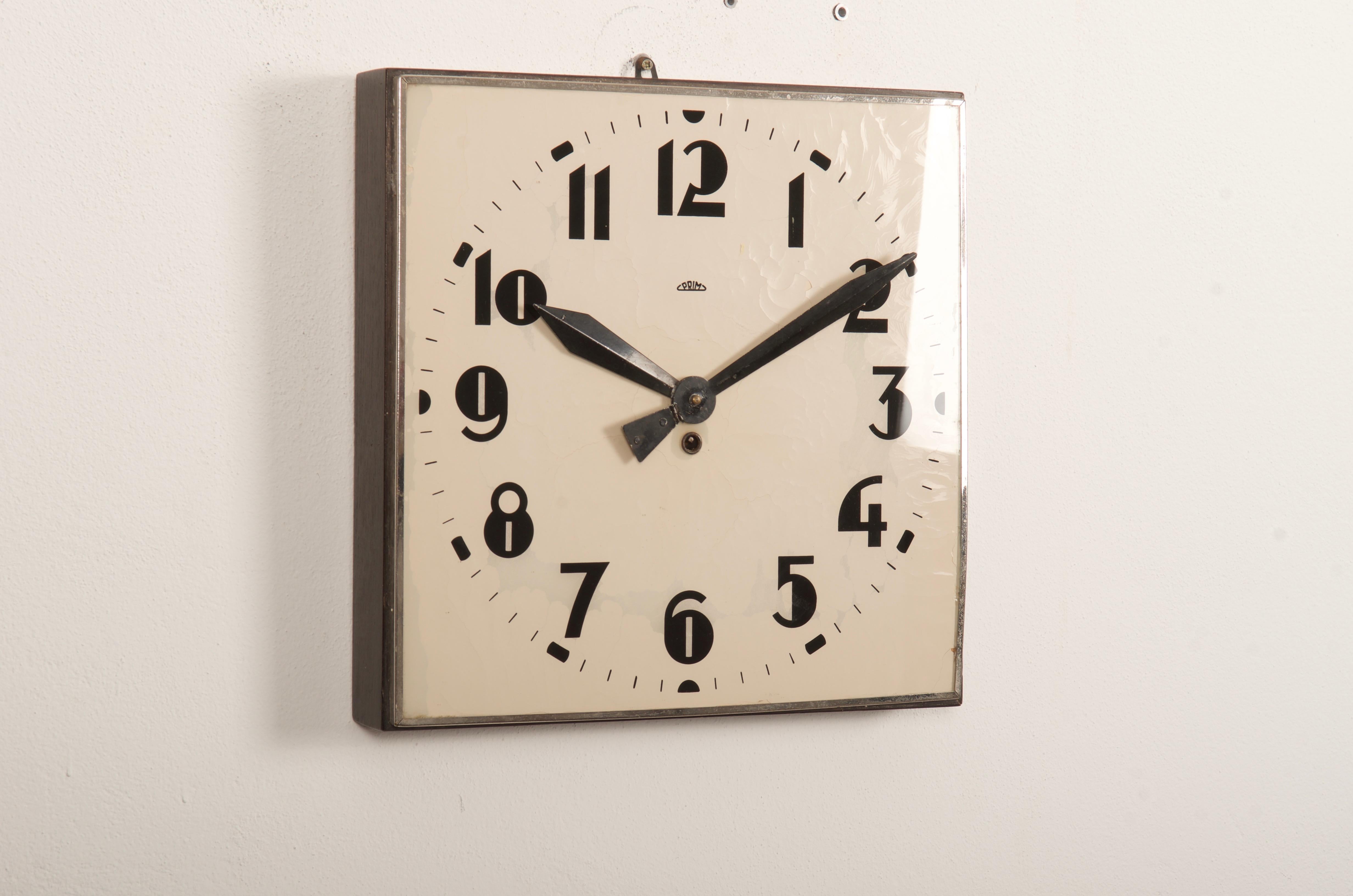 Wooden frame with white painted glass clock face and black digits caught in steel, made by Prim in the 1930s. The original movement is still working but it can be changes to an electric one powered with a small battery. Delivery time 2-3 weeks.