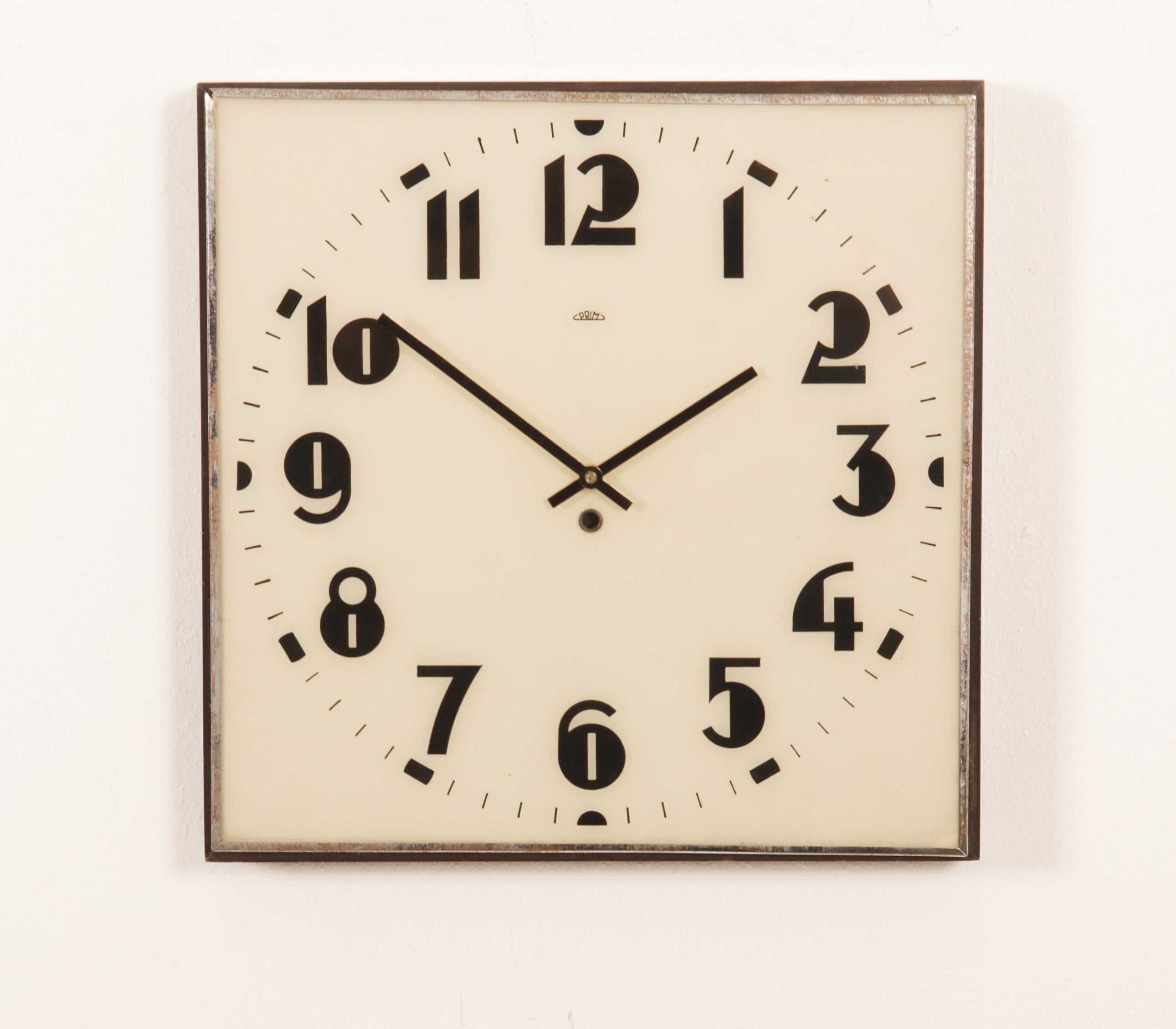 Wooden frame with white painted glass clock face and black digits caught in steel, made by Prim in the 1930s. The original movement replaced to an electric one powered with a small battery.