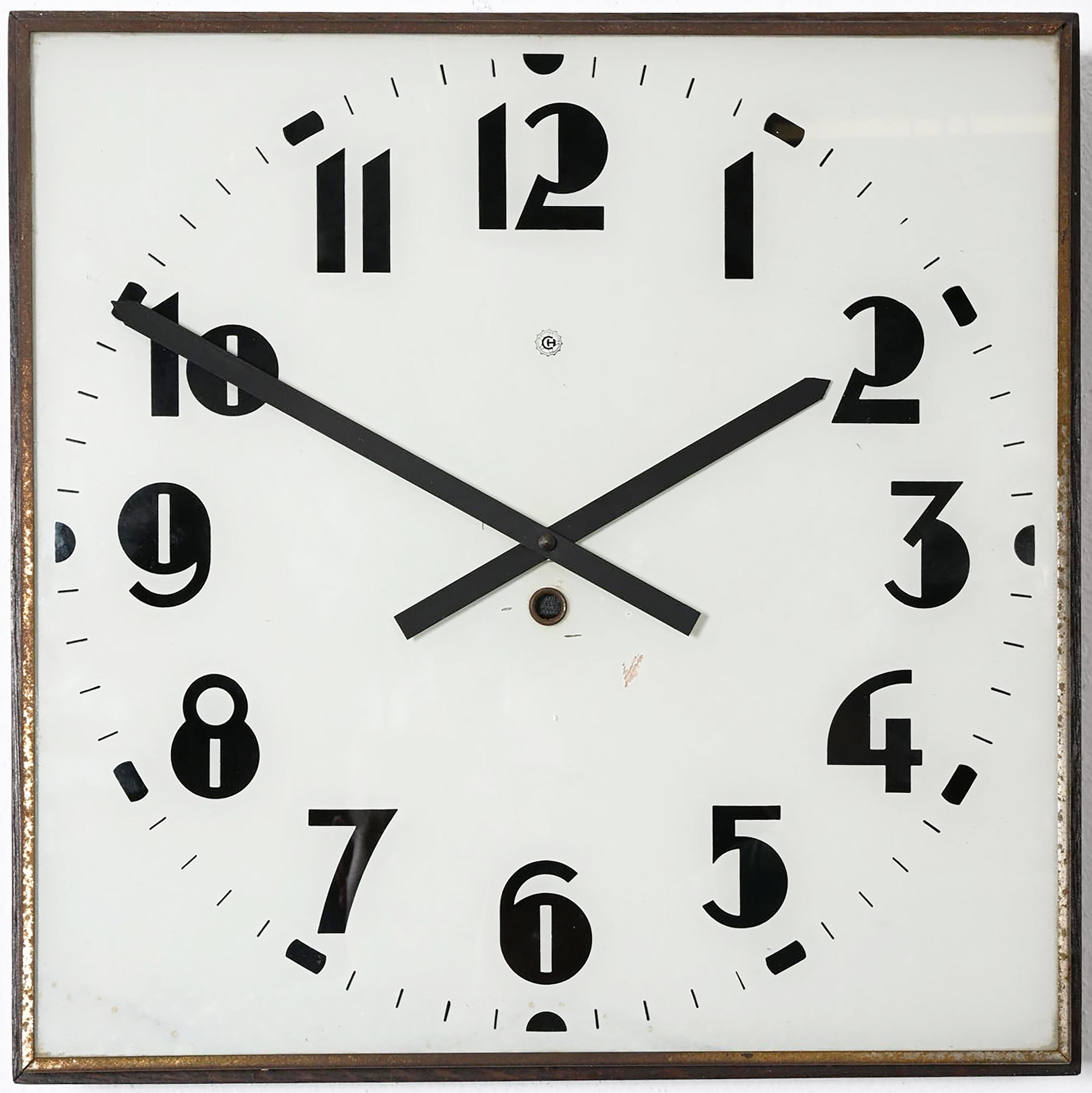 Very rare wall clock made of wooden frame with white painted glass clock face and black digits caught in steel, made by Chomutov in the 1930s. The original movement replaced to an electric one powered with a small battery.
