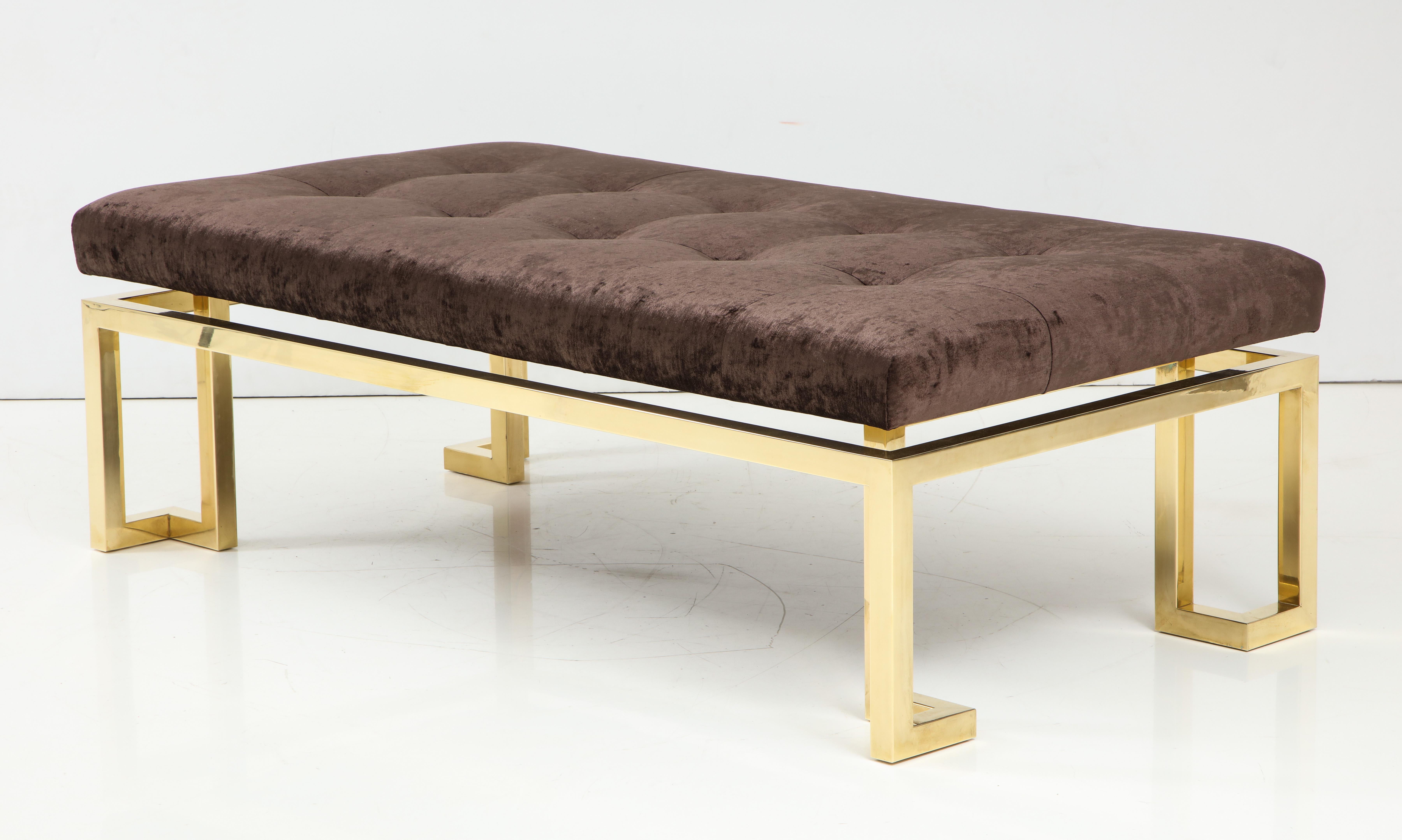 Large polished brass Greek key upholstered bench.
The heavy brass frame supports the newly reupholstered biscuit tufted
top which is in a rich chocolate brown velvet fabric.