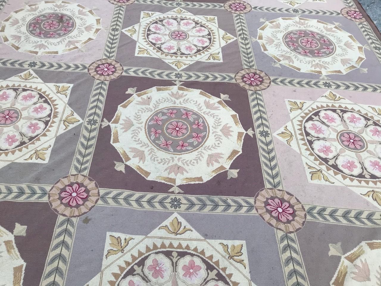 Nice large rug with a beautiful Aubusson Louis XVI design, and light colors with pink, grey and purple, entirely hand needlepoint embroidered with wool on cotton foundation.