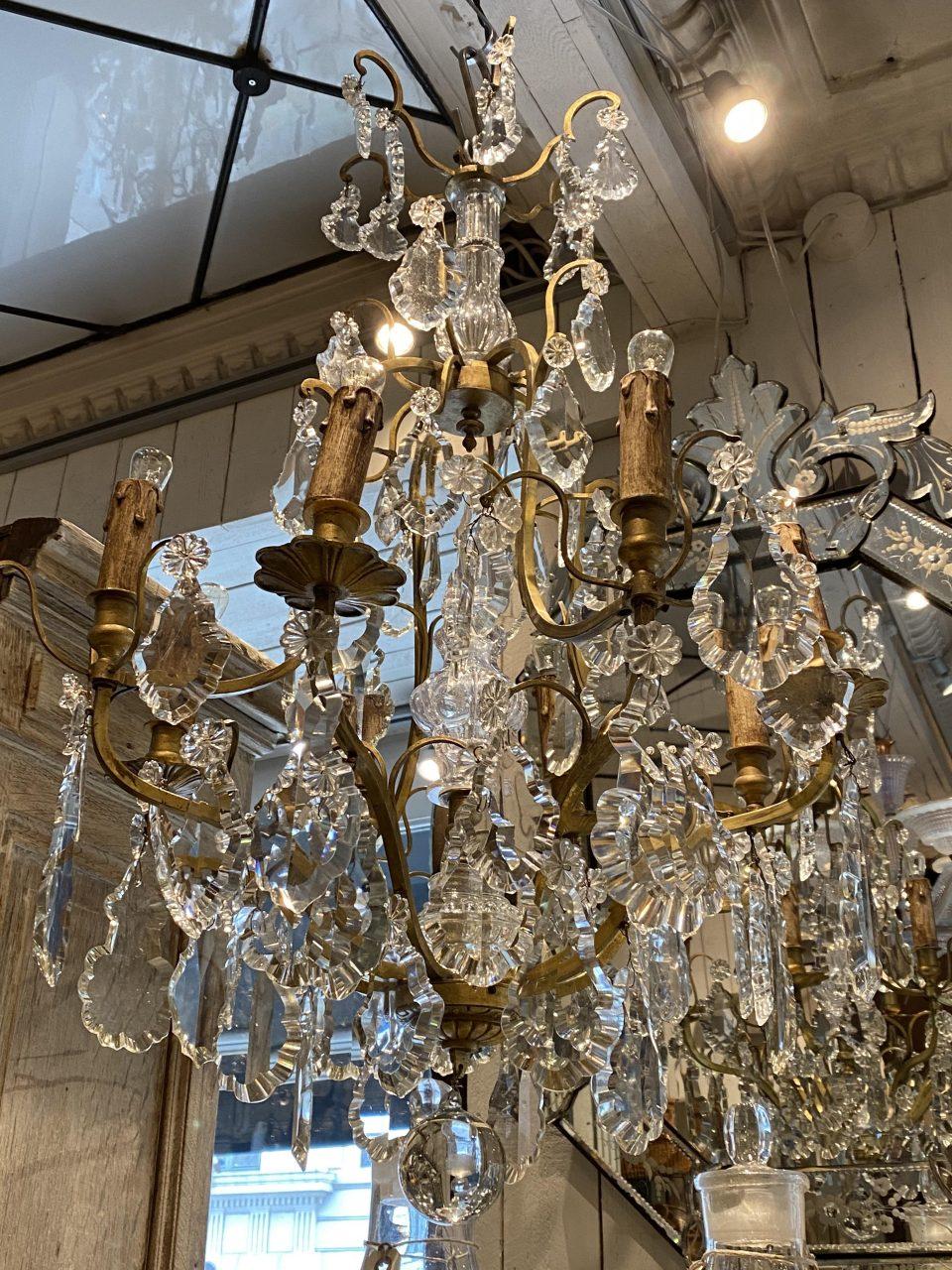Beautiful large antique brass cage framed glass prism chandelier, France, circa 1900. Numerous lovely crystal prisms adorn it.

This opulent ceiling lamp’s beautiful faceted prisms are in various sizes, and in charming clear tones, elegantly