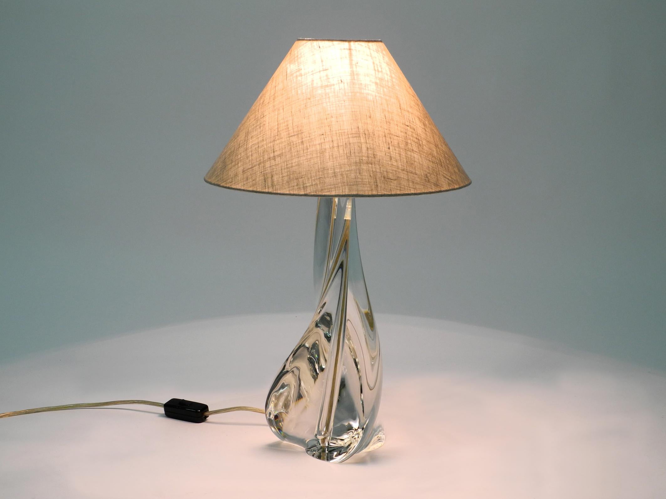 Beautiful large heavy French midcentury table lamp. The lamp base consists of hand blown and twisted solid crystal glass.
Manufacturer is St Louis France. The renowned French glass manufacturer Maison Saint Louis, the oldest art glass manufacturer
