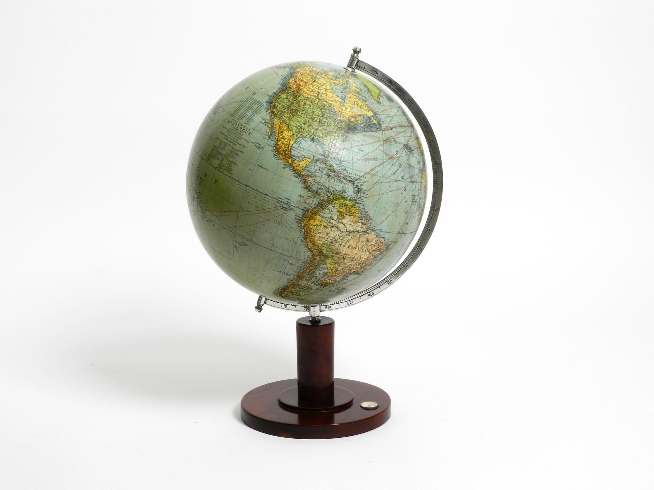 Beautiful 1950s Columbus globe.
Scale 1:40,000,000.
Produced by Columbus Verlag Paul Oestergaard K.G. Berlin and Stuttgart.
Shiny walnut base with a small functioning compass.
The globe is made of bakelite. The axle is made of metal.
The globe is in