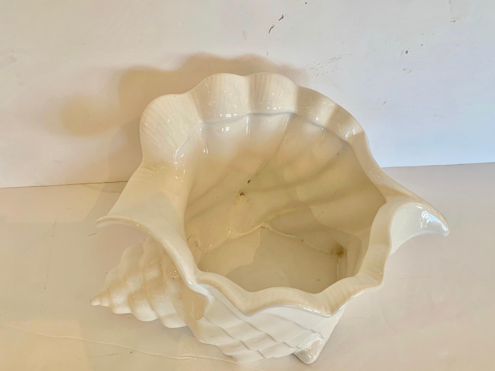 Eye catching large white ceramic flower pot planter in the shape of a lovely nautilus shell.