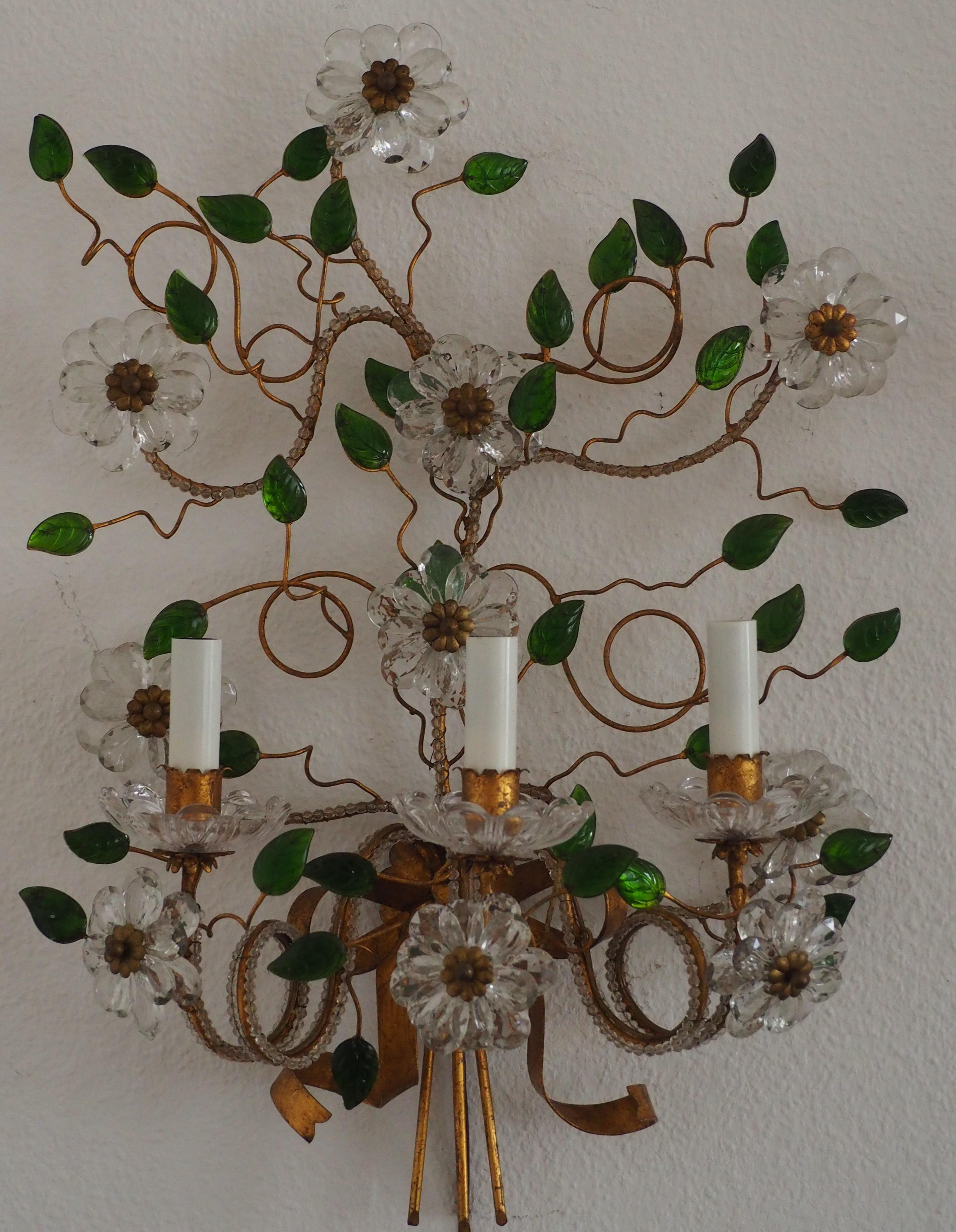 A beautiful, very large three - light wall sconce attributed to Maison Baguès, France, circa 1950s.
This wonderful wall light is made of gilt iron, glass flowers and green glass leaves.
Socket: 3 x Edison (E14) for standard screw bulbs.
The