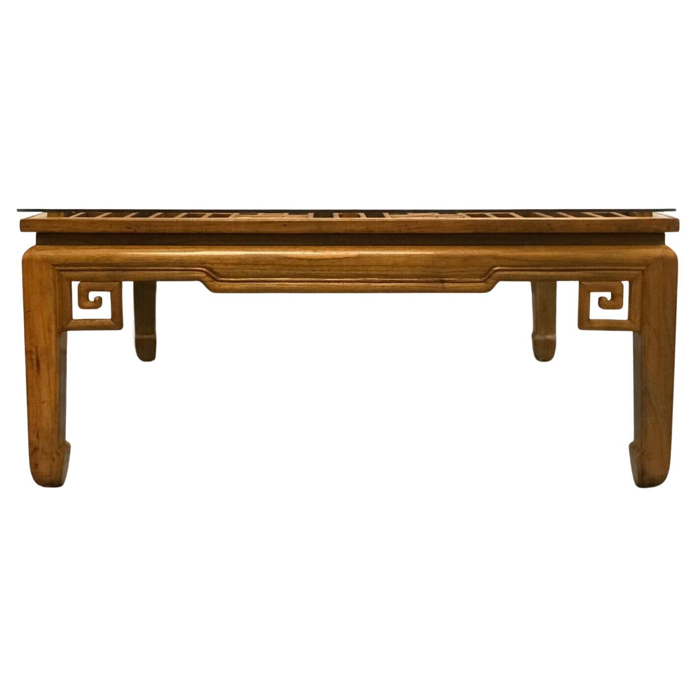 We are delighted to offer for sale this gorgeous large square Chinese coffee table with glass top.

The small pieces of teak are individually put together to form a nice classic pattern. The glass is standing on top of teak in each corner, giving