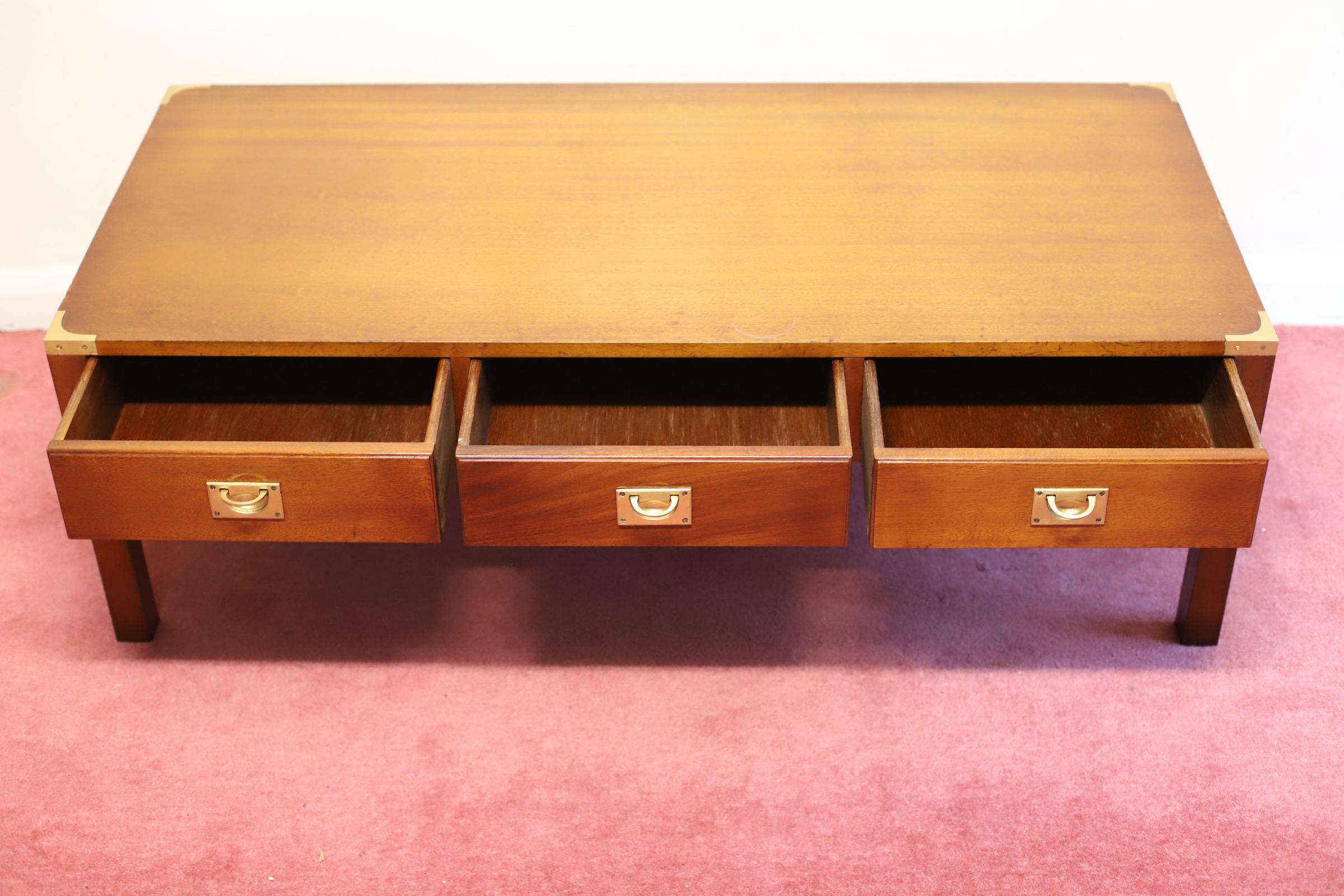 Large yew wood coffee table in the antique campaign style dating from around the 1930’period & in good condition. It has brass military inset handles & corner fittings on the back & front. There are three drawers on the front & three dummy drawers