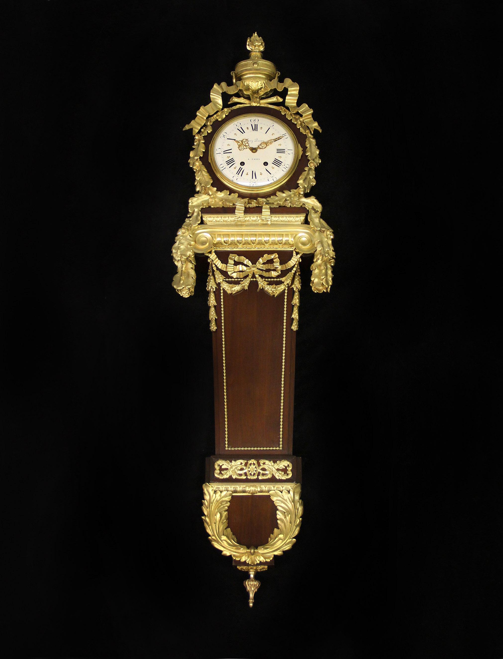 A Beautiful Late 19th Century Gilt Bronze Mounted Cartel Clock By Henry Dasson

Henry Dasson – After Martin Carlin

This large and fine cartel clock with a white enamel dial festooned with gilt bronze trailing oak leaves and surmounted by a