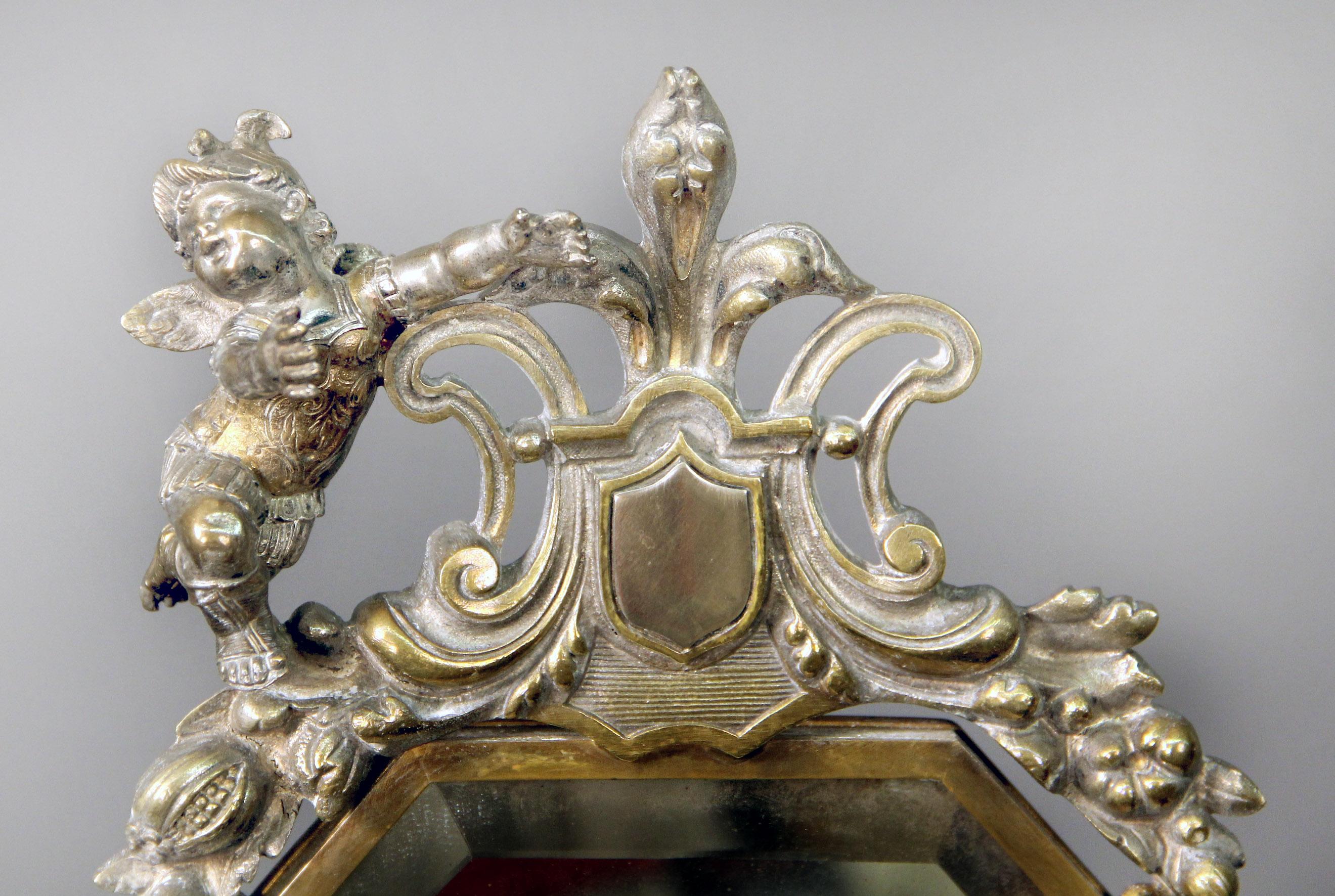 A beautiful late 19th century silver plated dressing table mirror.

The very fine mirror is surrounded by women masks and cherubs in dressed in armor, a rope and tassel run along the side of the swivelling mirror, the base with a pieced gallery