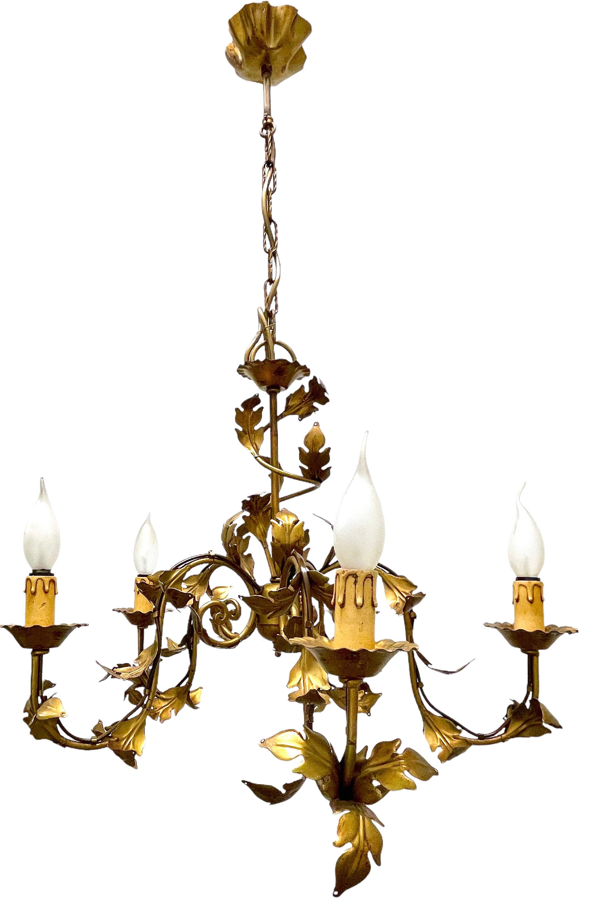 A Hollywood Regency midcentury gilt tole chandelier, the fixture requires five European E14 candelabra bulbs, each bulb up to 40 watts. This light has a beautiful patina and gives each room an eclectic statement. Lightbulbs shown in the pictures are
