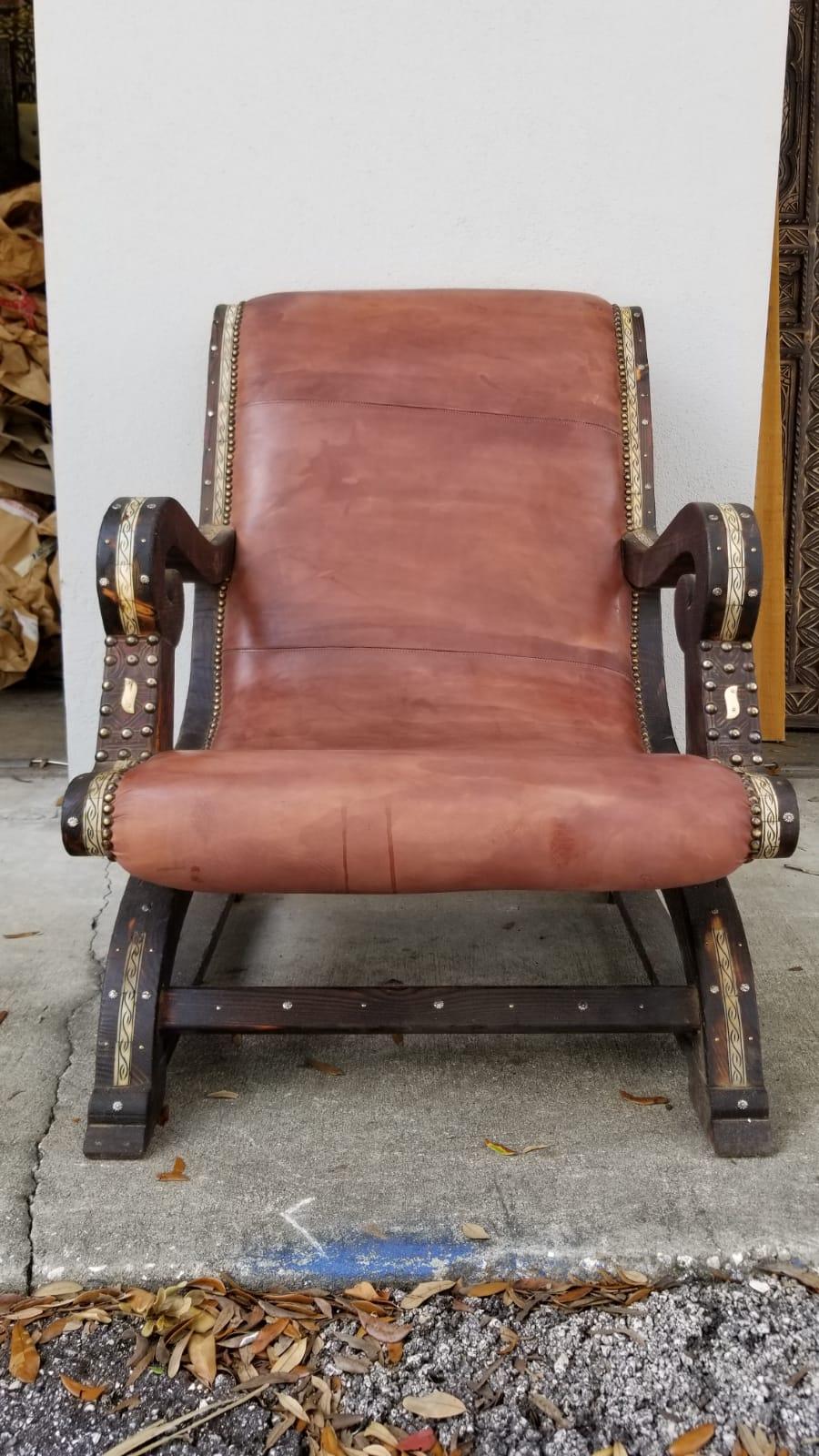 Beautiful leather inlaid cedar chair with camel bone from Morocco and very comfortable. Measures: 22 inside wide.
It’s hand tanned leather. It’s a moorish Andalusian chair vintage with several pieces recovered from an old British diplomats riad.