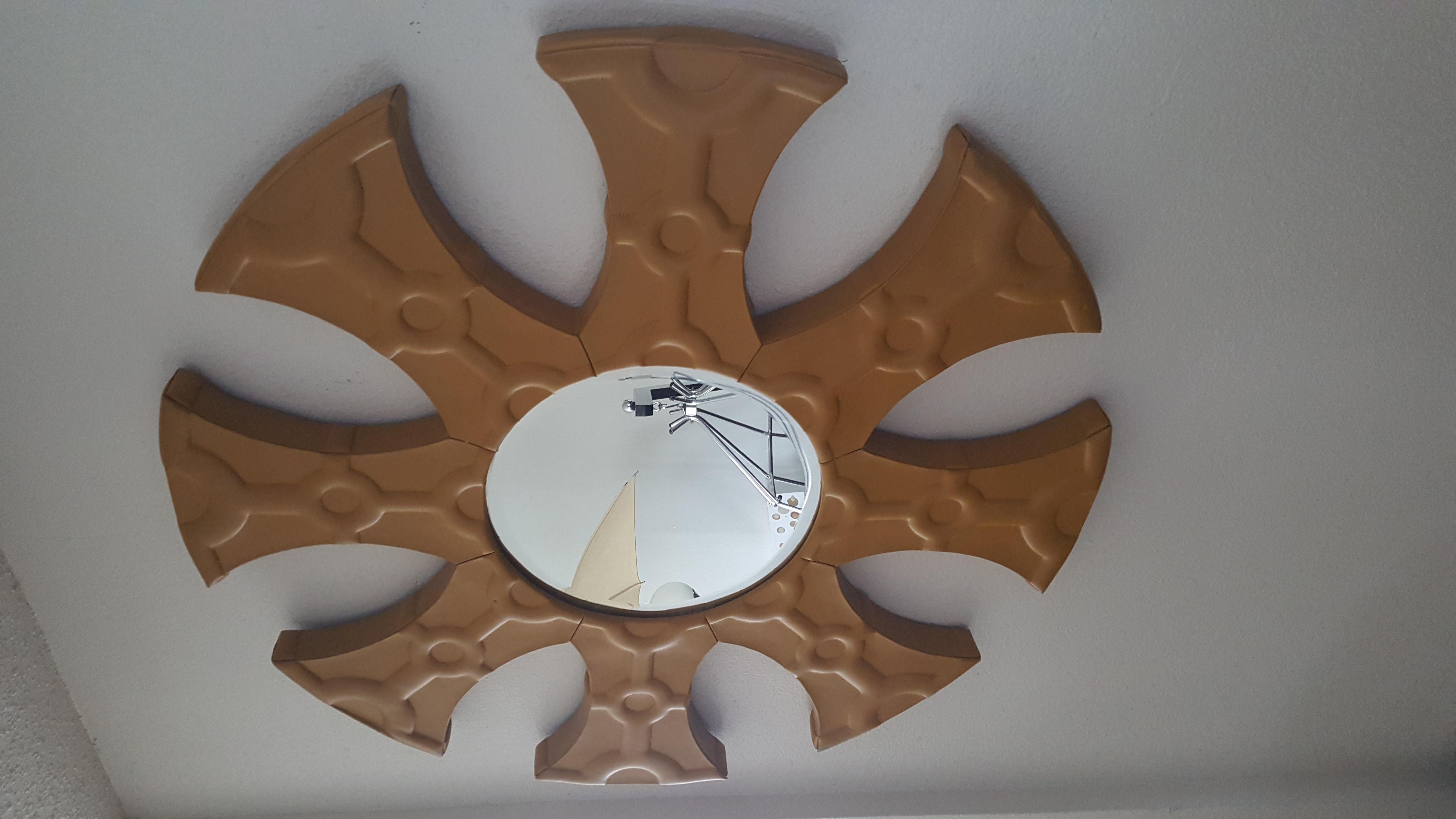 Incredible leather wall hanging mirror with great abstract designs which gives a wall a very creative look.