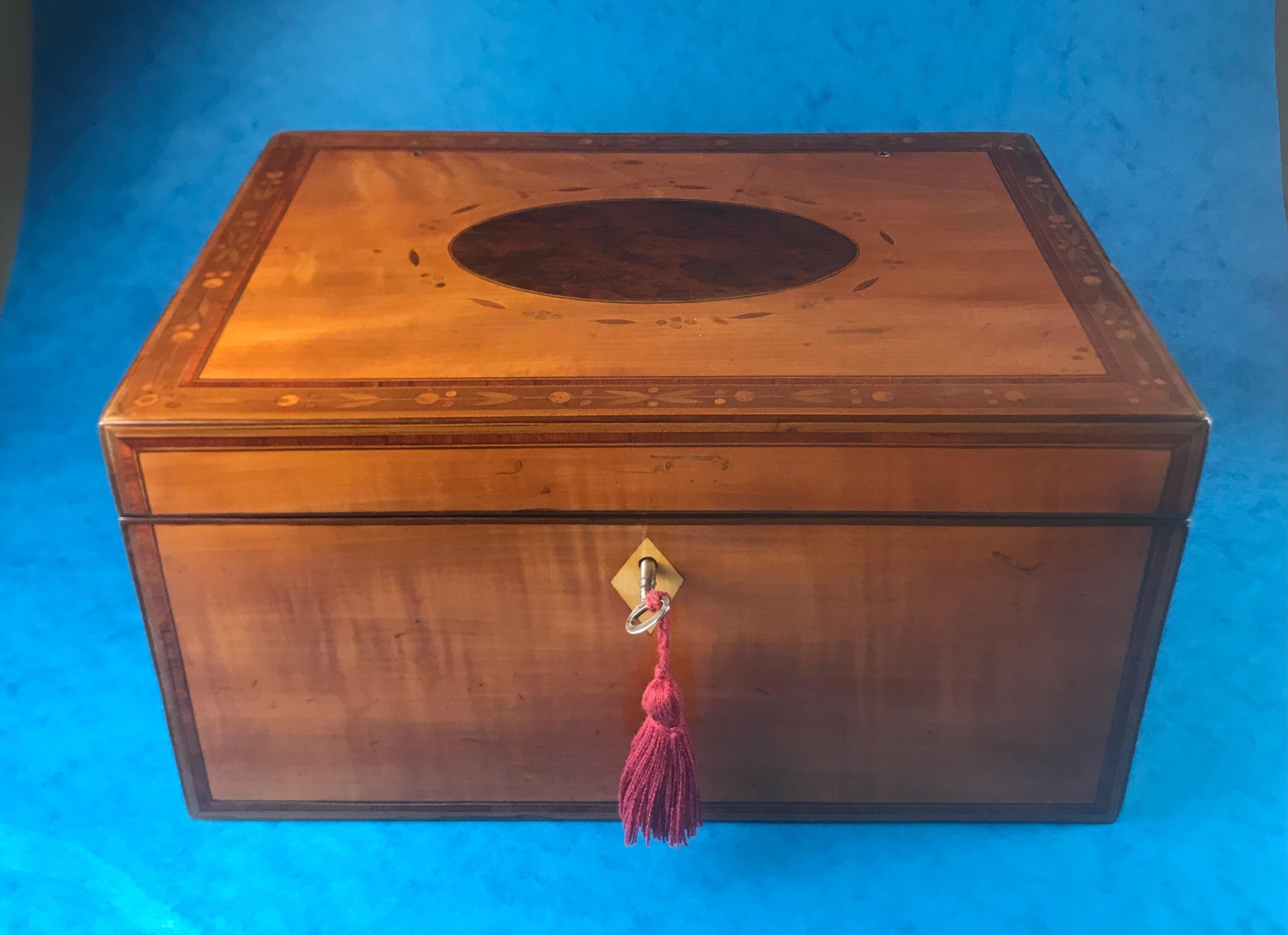 A beautiful little 18th century 1790 Sheraton writing slope it is satinwood with a burr yew panel to the top with harewood leaves surrounding the panel and the border it is cross banded with tulipwood it comes with a reading lectern a working lock