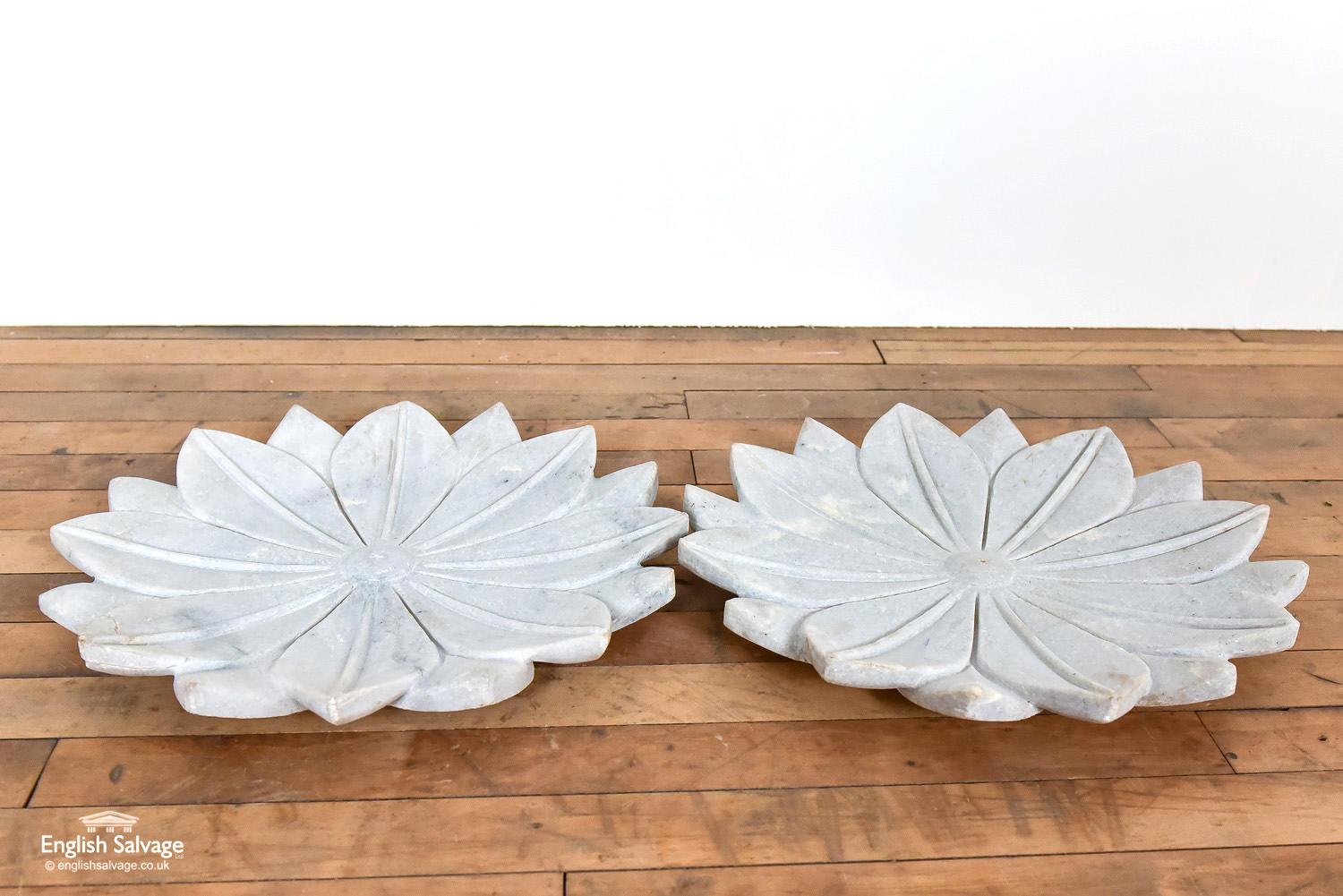 These exquisite marble plates are hand carved from marble in the shape of a lotus flower. The natural stone has marks and veins to it, and there is a crack along the vein at the edge of one of the petals.