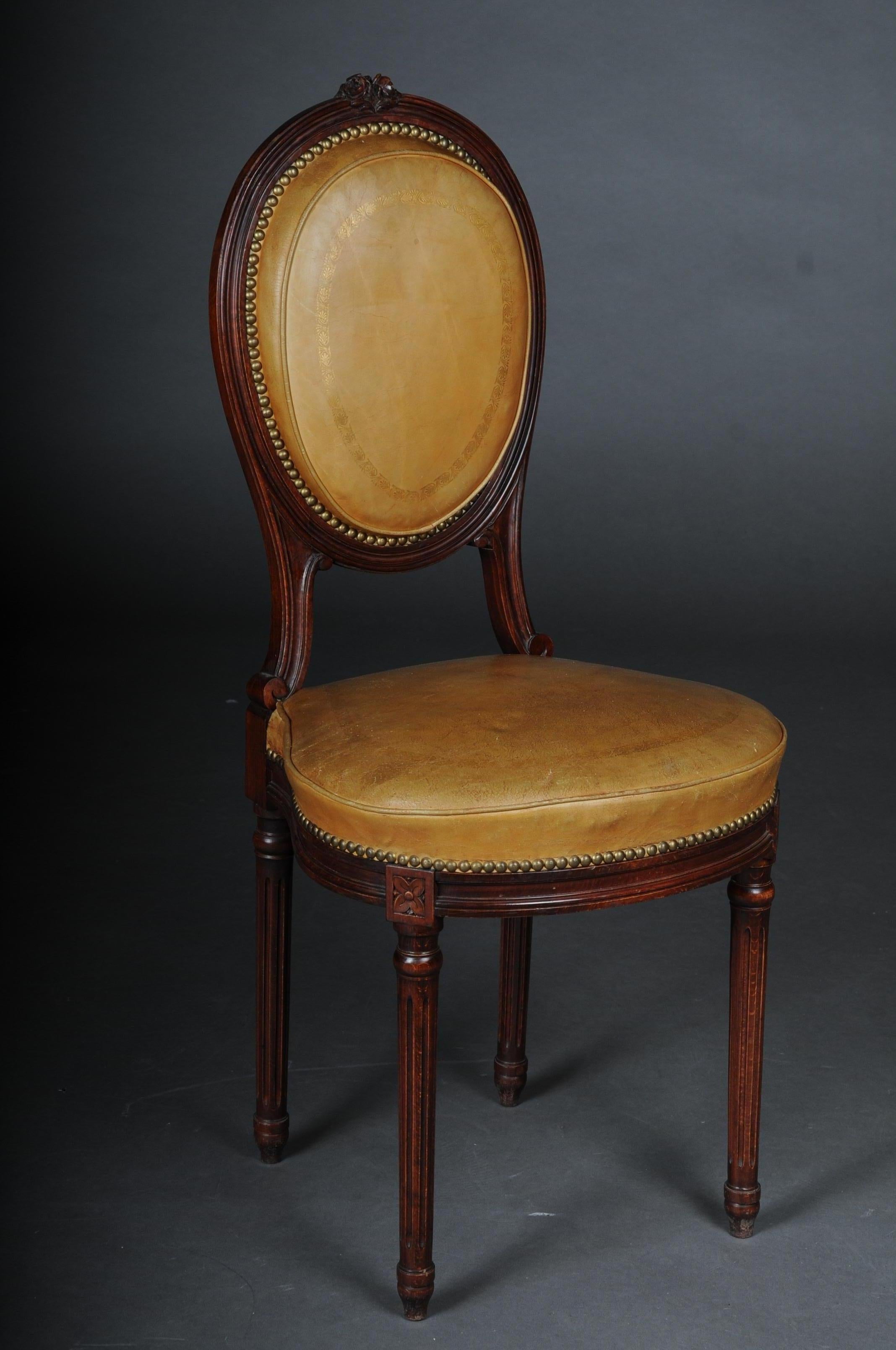 Beautiful Louis XVI salon chair, France around 1920

Solid wood frame stained in mahogany. Medallion-shaped seat and backrest frame covered with yellow leather. Long, fluted legs. Extremely high quality. The seat and backrest are finished with