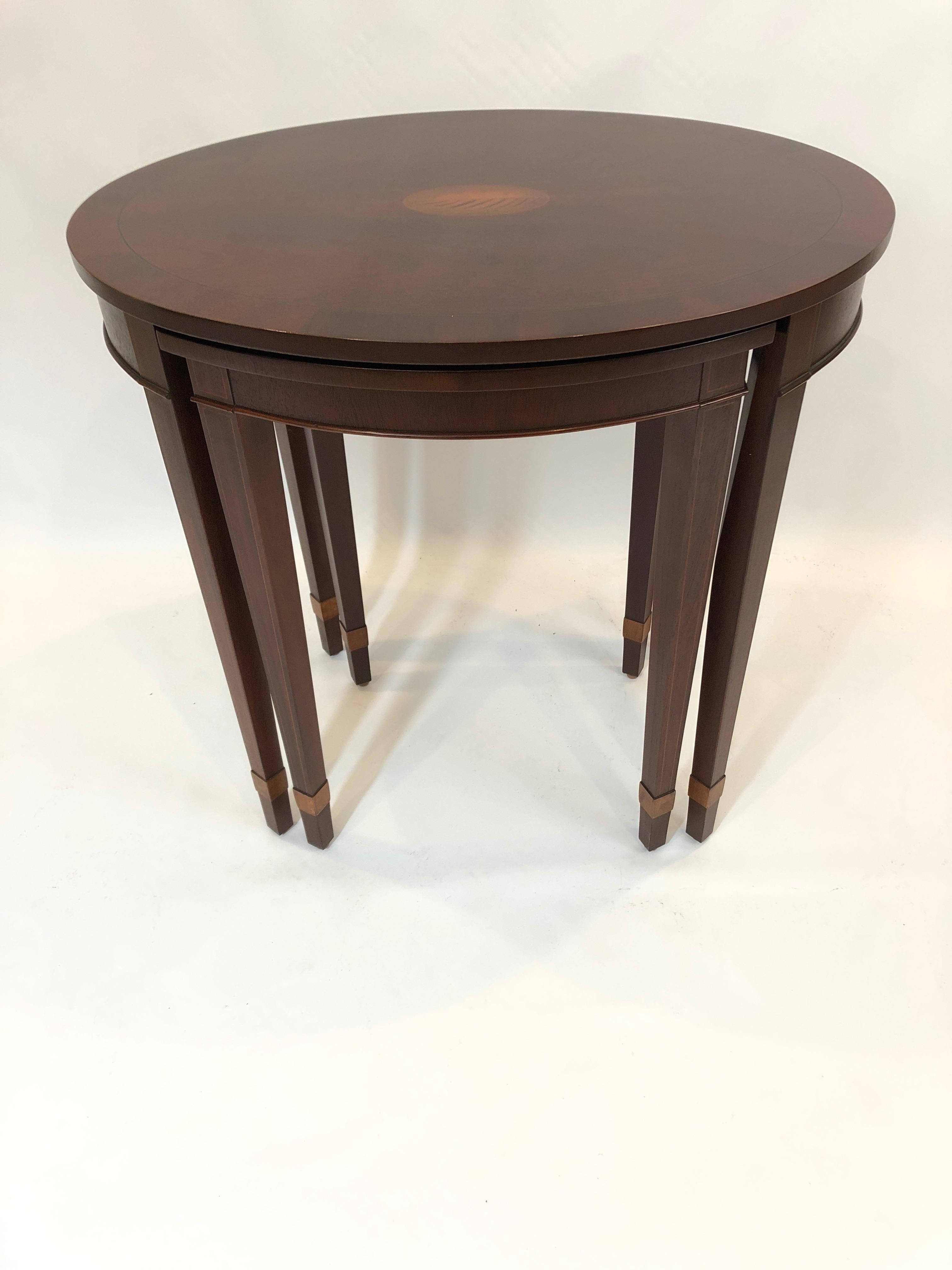 A gorgeous set of nesting tables by Baker, the large one having a lovely oval shape with inlaid central shell motif medallion, while the 2nd table is square with curved ends and measures 17 W x 17 D x 24.5 H.
