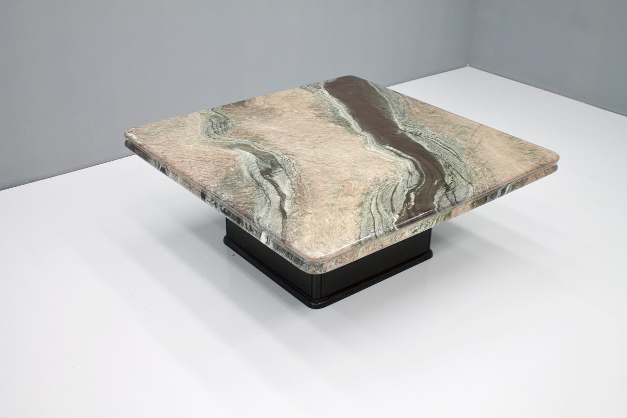 Beautiful coffee table with a fantastic marble top and a black wood base, 1970s.
Very good condition.
Details

Creator: unknown
Period: 1970s
Color: Black, gray
Style: Mid-Century Modern
Place of Origin: Italy
Dimensions: Height: 17.33 in. (44 cm)