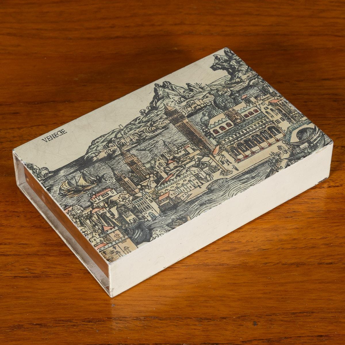 A rare matchbox or trinket box by Piero Fornasetti, made in Italy, circa 1960s / 1970s. The lacquered exterior is decorated with a traditional scene of Venice, the interior made with a cedar wood interior slide. These increasingly rare and