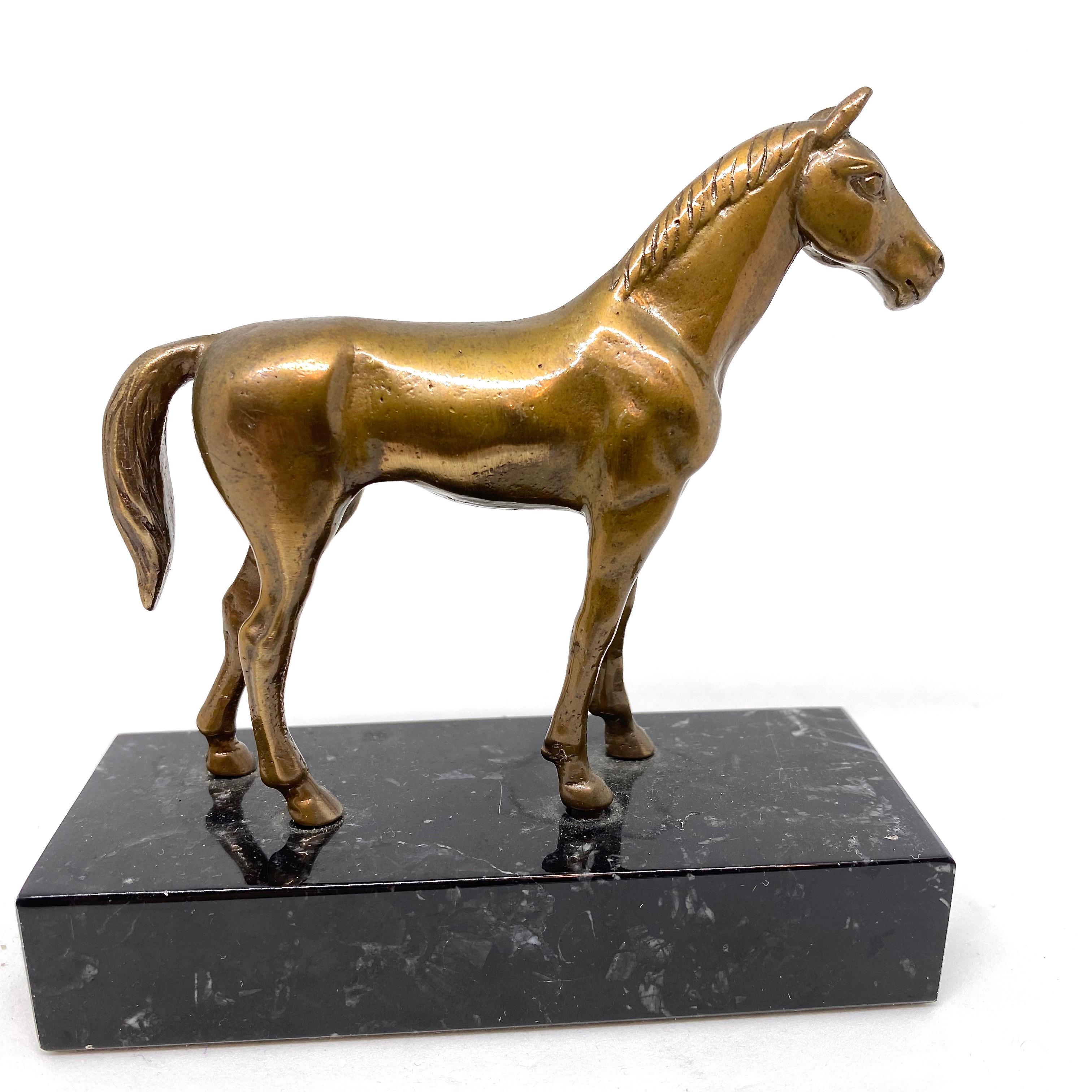 A decorative Horse sculpture. Some wear with a nice patina, but this is old-age. Made of metal and a marble base. This makes a nice addition to any room or just on your desktop, probably as a paperweight.