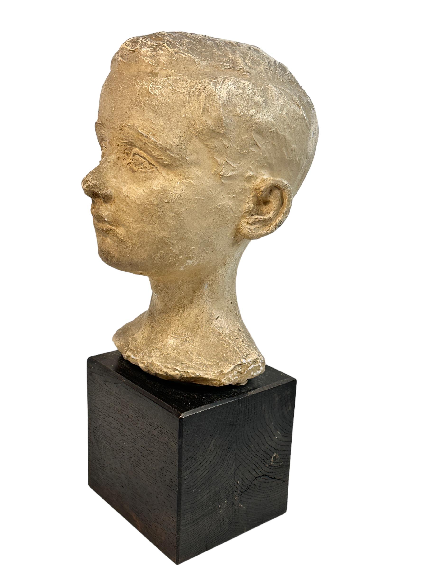 Beautiful mid century modern white plaster boys head bust. Bust with lots of patina. Plaster on a wooden base. A nice addition in every living room. Found at an estate sale in Nuremberg, Germany.
Signed by artist at the wooden base and dated. Can