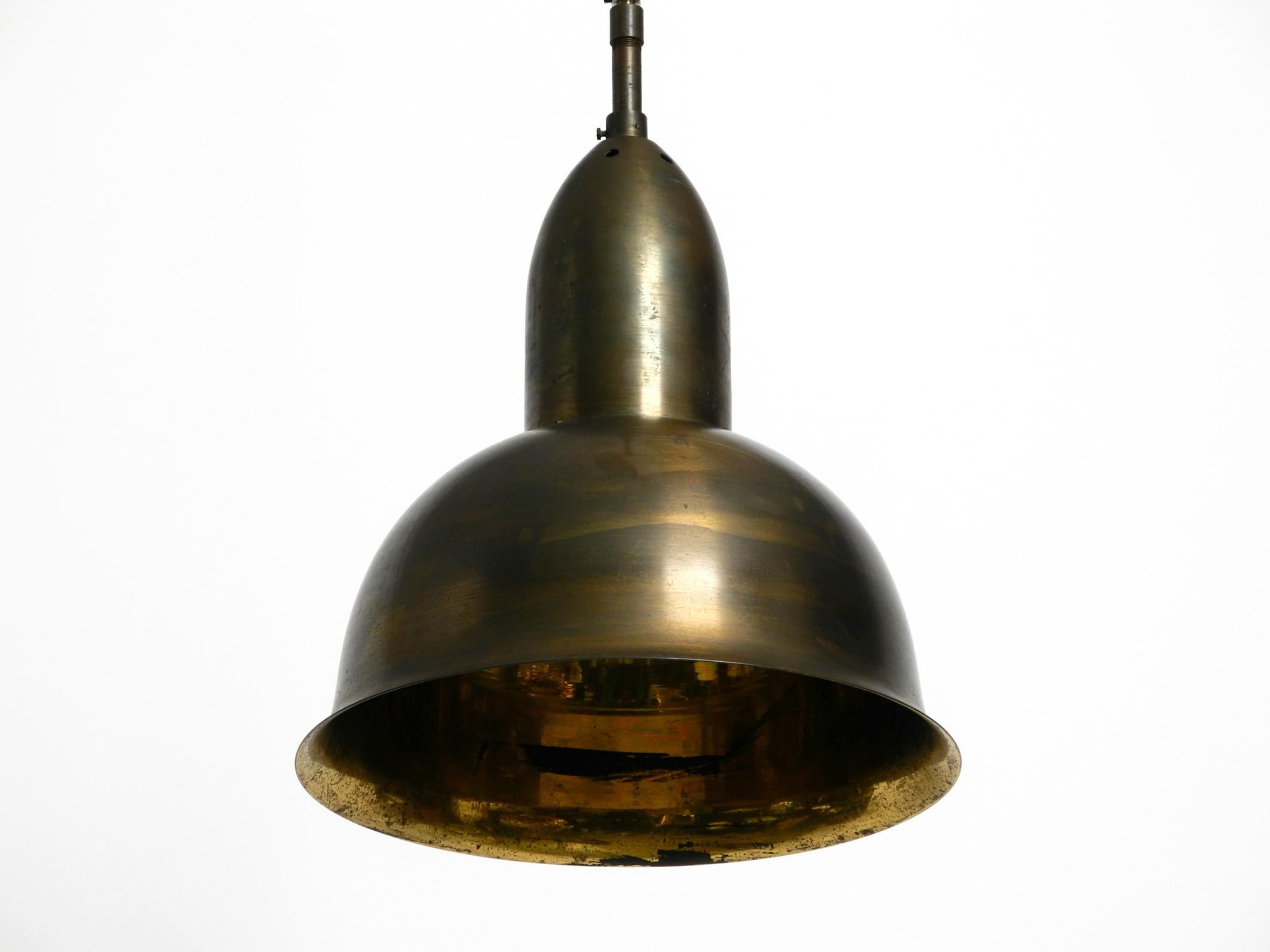 Beautiful original mid century brass pendant lamp.
This lamp hung in a German church for over half a century. 
Brass shade and socket.
100% original and fully functional.
One E27 socket for up to 100W.
Rewired due to age and with new metal