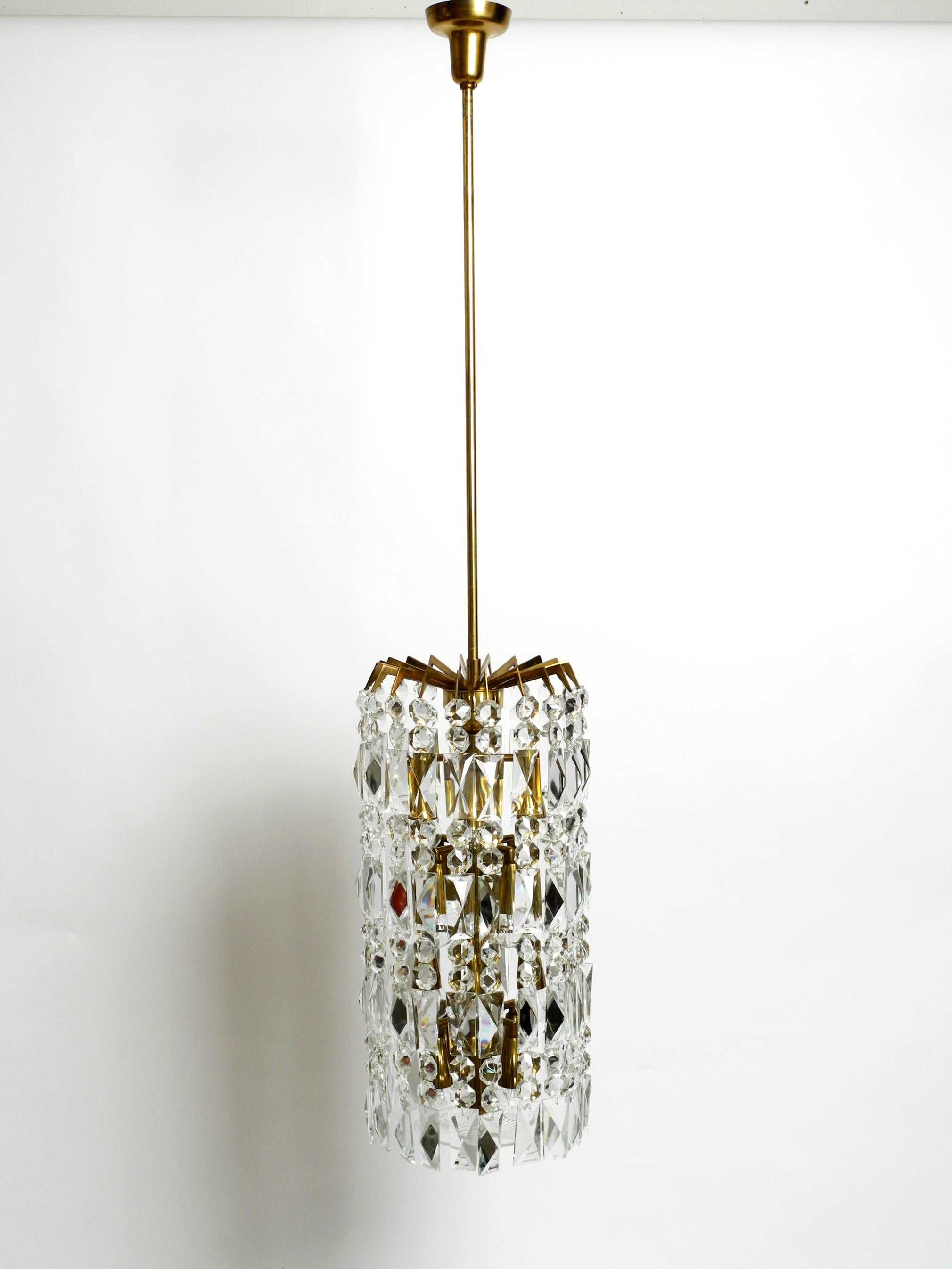 Very impressive beautiful rare Mid Century modern brass crystal glass chandelier. Manufactured in the 1960s by the Vereinigten Werkstätten.
There are 20 crystal glass stone chains hung in a circle.
Elaborate, very high-quality design with 16 E14