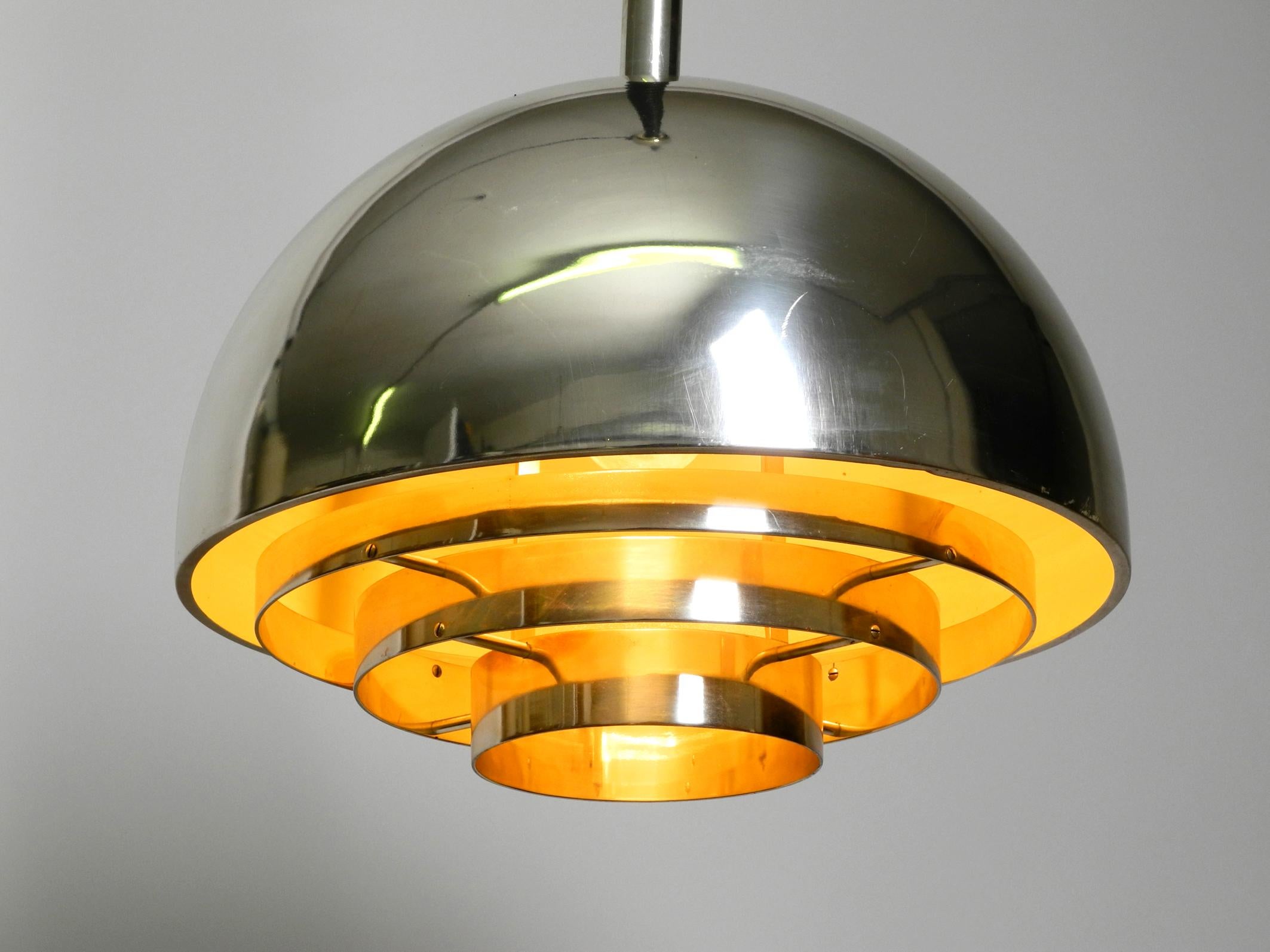 Beautiful and rare large mid century ceiling lamp by the Vereinigte Werkstätten.
Very nice mid century slat design with dome shape.
Heavy, high-quality, elegant workmanship made of solid metal and silver-plated shade and canopy.
The lamp is