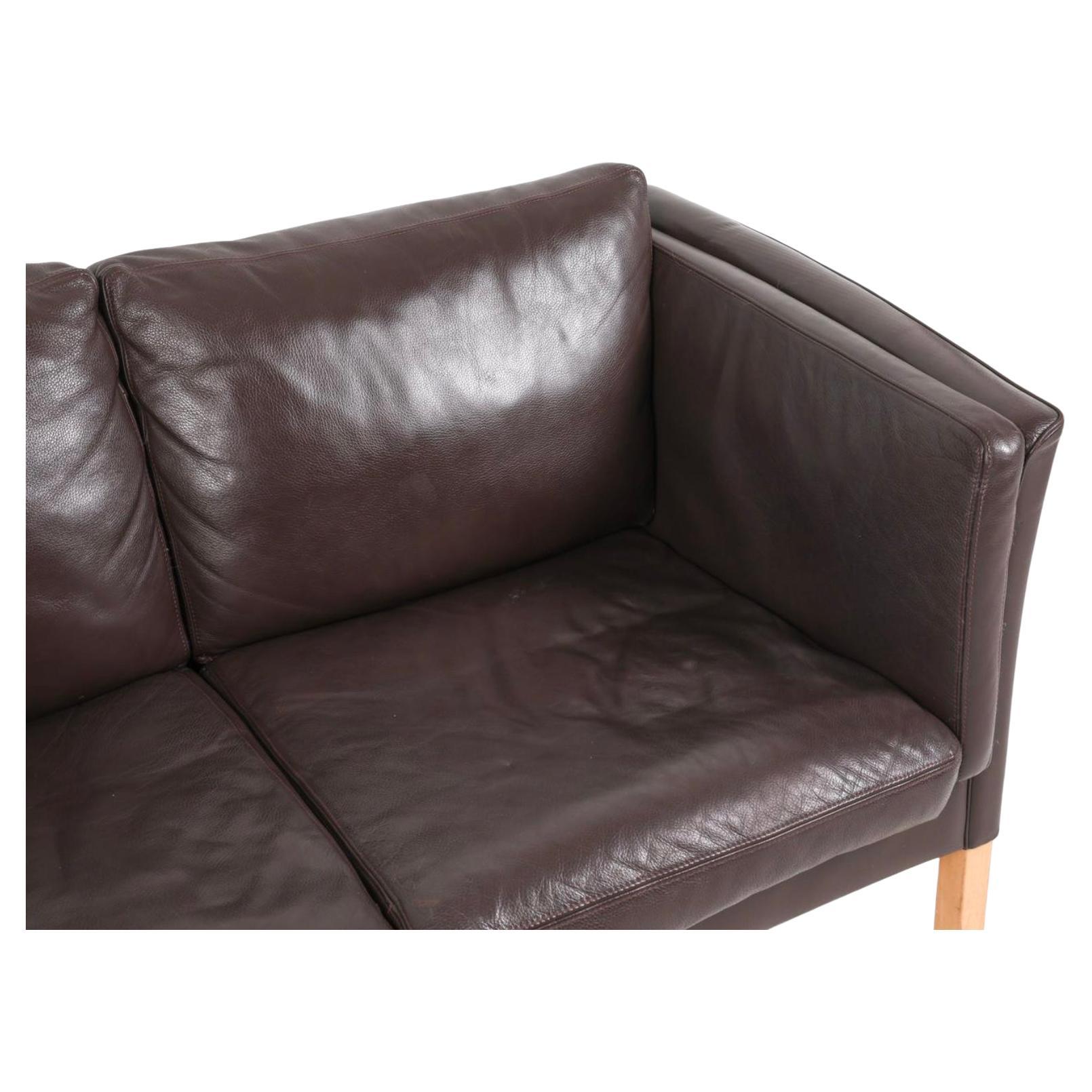Great mid century Danish modern tan leather 2 seat loveseat sofa with Square birch legs. Beautiful thick Dark brown leather is soft and shows very little signs of use but broken in nicely. Dark Brown leather. Great Danish Modern sofa has original
