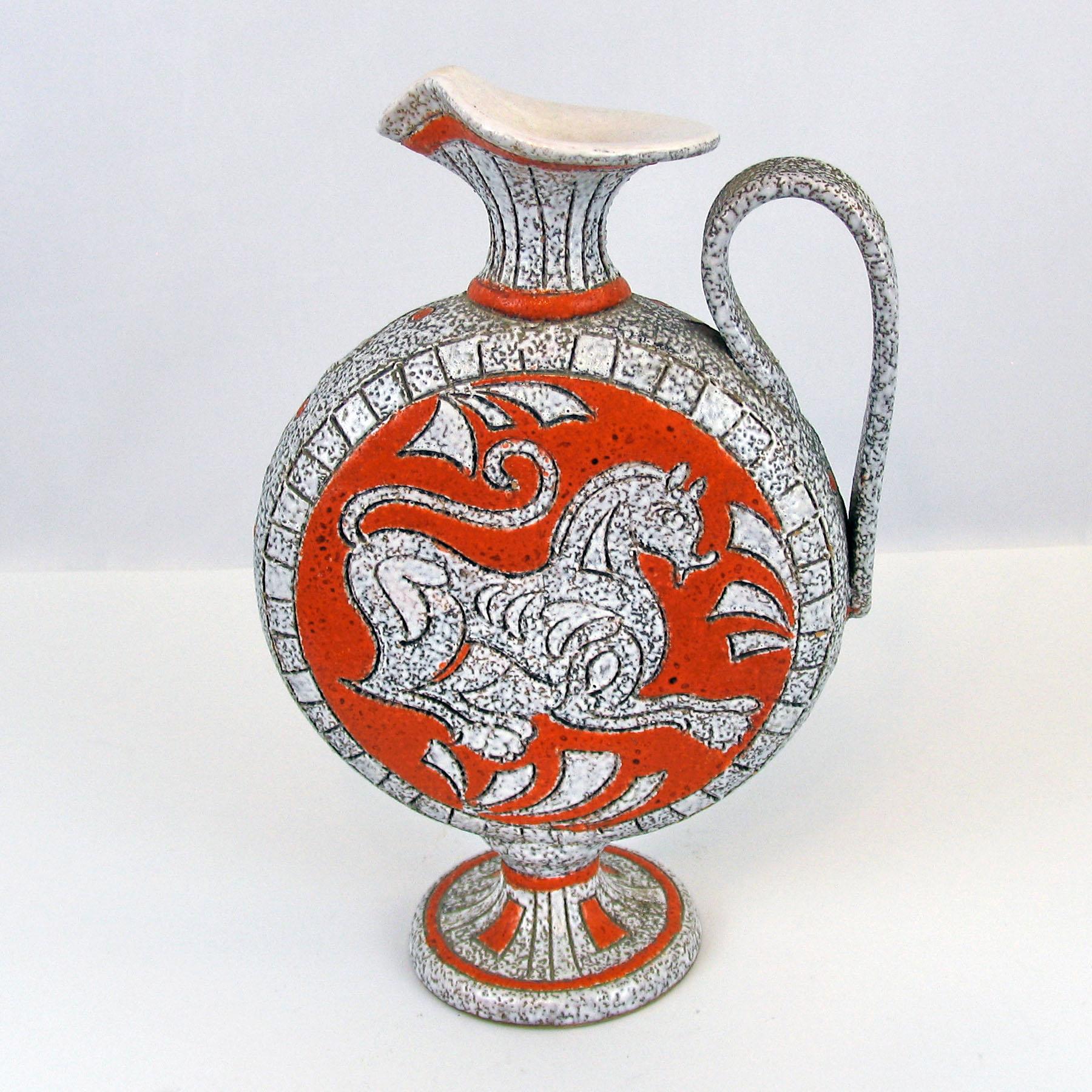 Beautiful pottery jug/handled vase, Italy late 1950s-1960s. Signed.

A stunning form and décor, body shaped as a jug, glossy white spray-glaze has a mottled texture, decorated using the sgraffito technique with motifs of Greek horse and leafage,