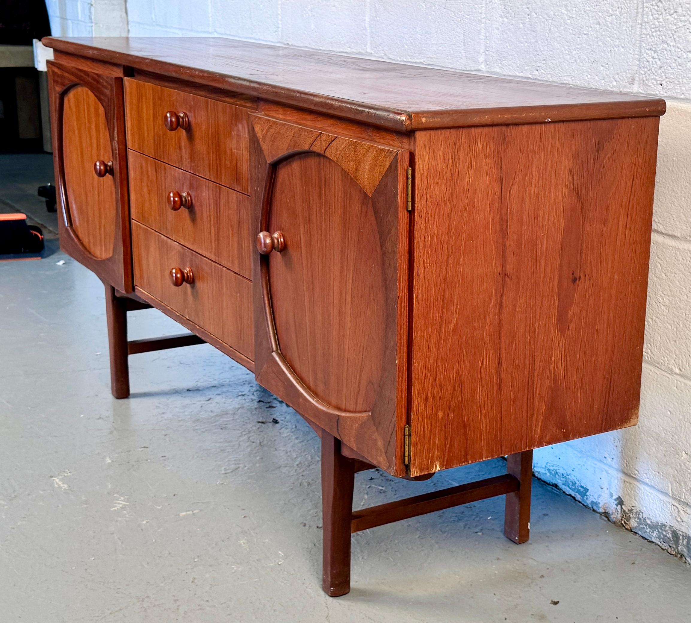 Bring classic sophistication and functional style into your home with this Mid-Century Modern wooden sideboard, a beautifully crafted piece that embodies the clean lines and warm tones that define the era.

Please confirm location with seller (NY or