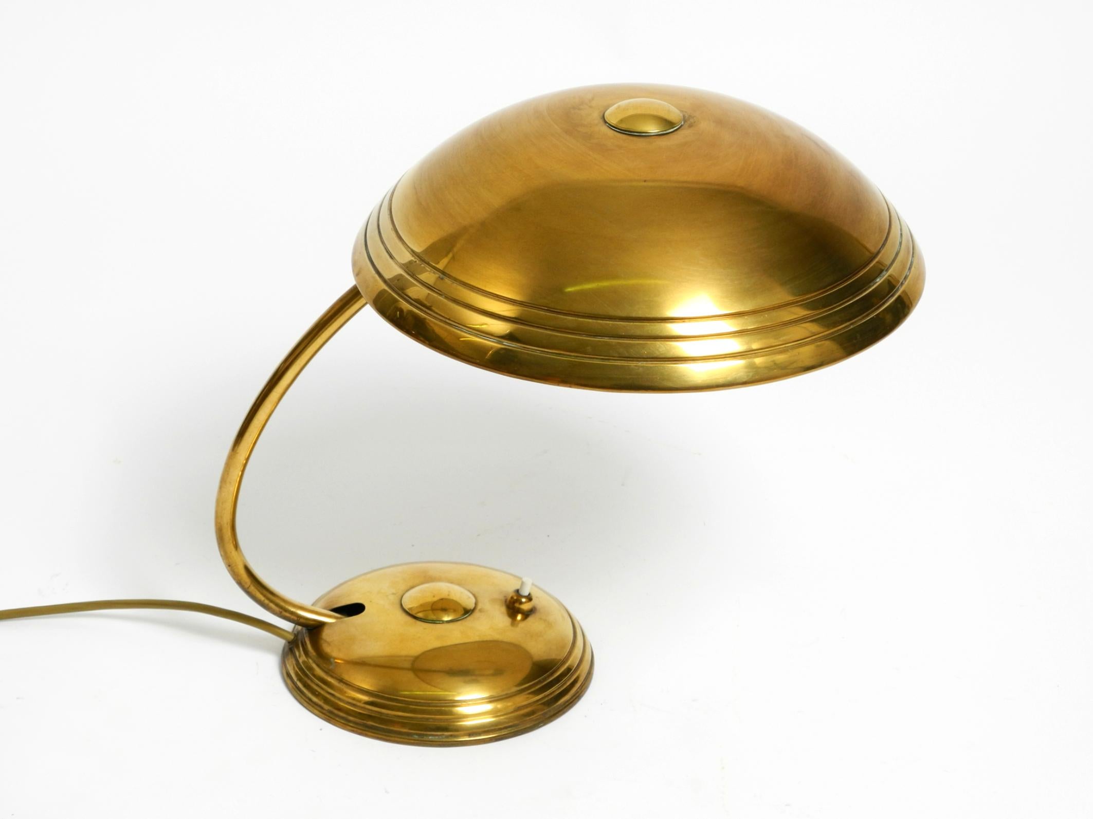 Beautiful Mid Century Modern brass table lamp by Helo.
A fantastic 1950s German minimalist design in very good condition.
The shade and neck are steplessly adjustable and will stay in any position.
Very good vintage condition with no damage.
No