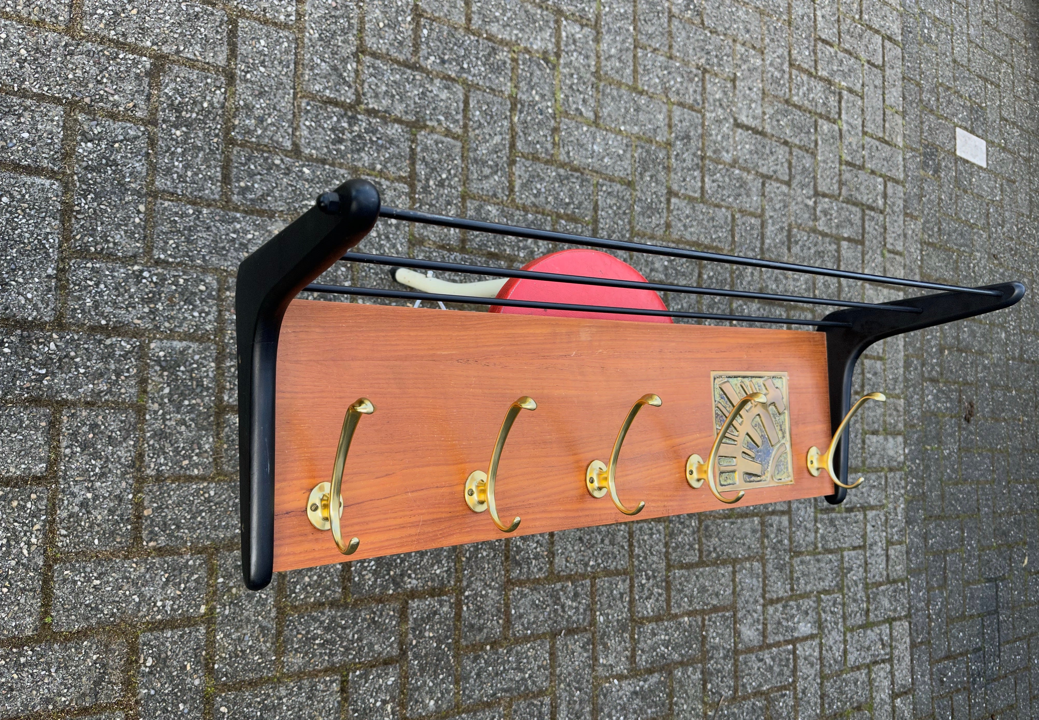 Great quality and condition Mid-Century wall coat rack with a hat rack on top.

This beautifully designed, perfectly executed and highly practical Mid-Century coat rack could be the ideal piece to come home to. Thanks to the metal hooks on the back