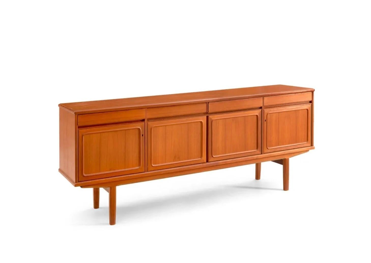 Beautiful Mid Century Scandinavian modern teak credenza sideboard.
Made in Norway, c. 1965. Wonderful light teak wood with (4) upper short drawers and (4) lower cabinet doors. The cabinet doors open to interior with shelving. Has Key holes to lock