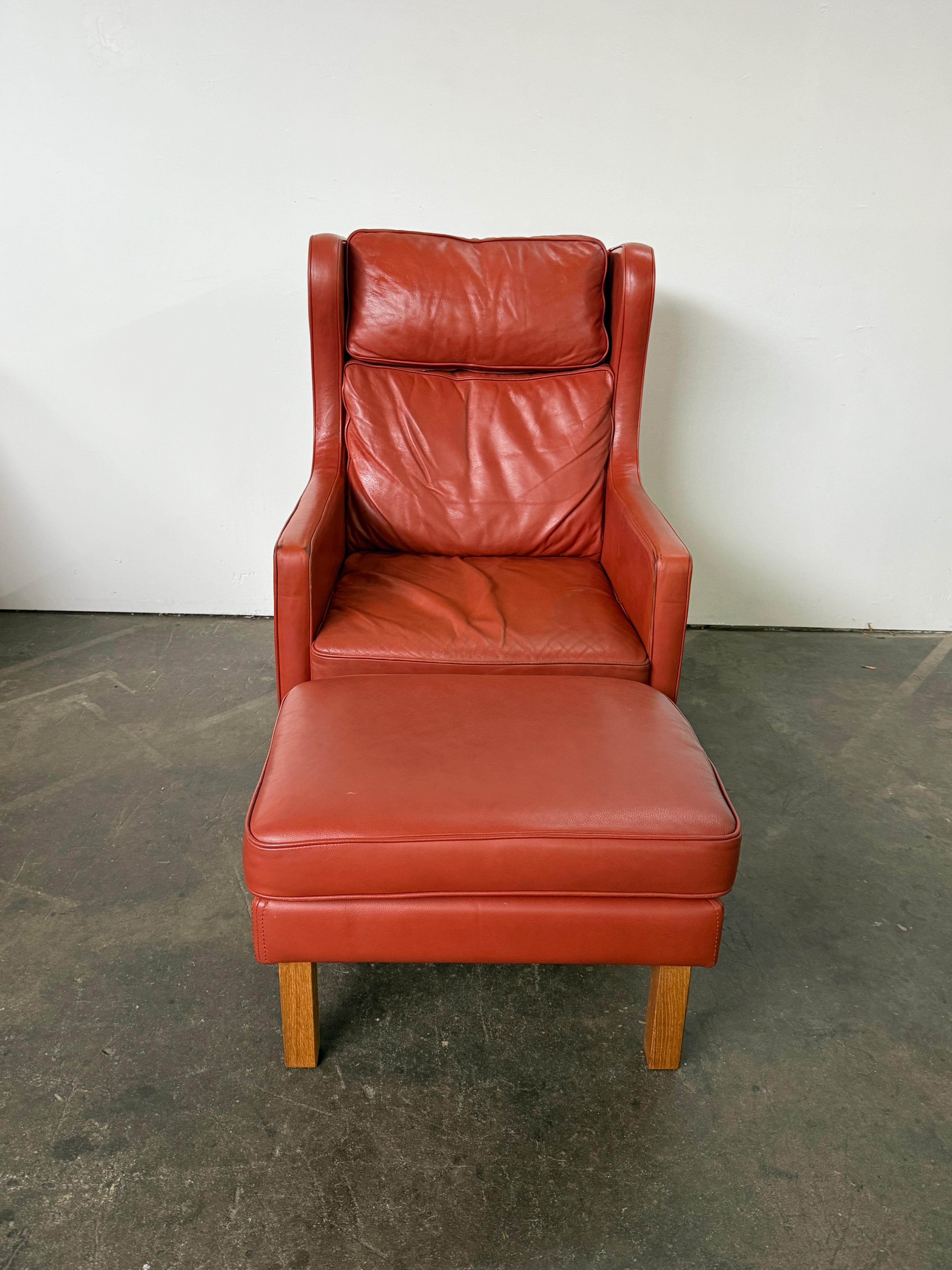 Beautiful Mid Century Scandinavian modern Terra cotta Red Leather Wingback Chair and Ottoman in the style of Børge Mogensen. Very clean chair with light beech wood legs and soft terra cotta Red leather. Very comfortable chair great for your beach