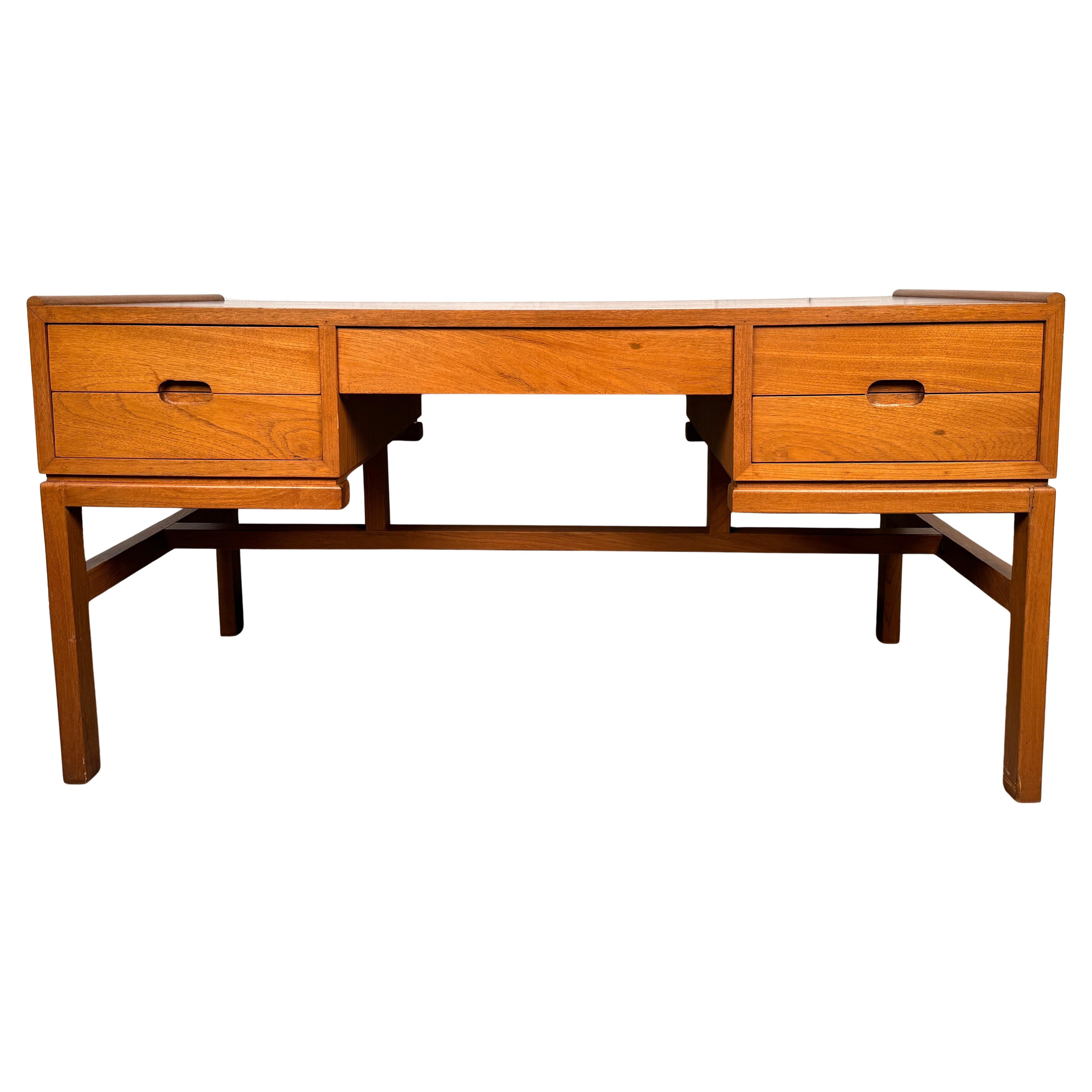 Elevate your workspace with this stunning mid-century teak desk designed by Arne Wahl Iversen, a masterful example of Danish modernism. Known for his clean lines, thoughtful proportions, and exceptional craftsmanship, Wahl Iversen created timeless