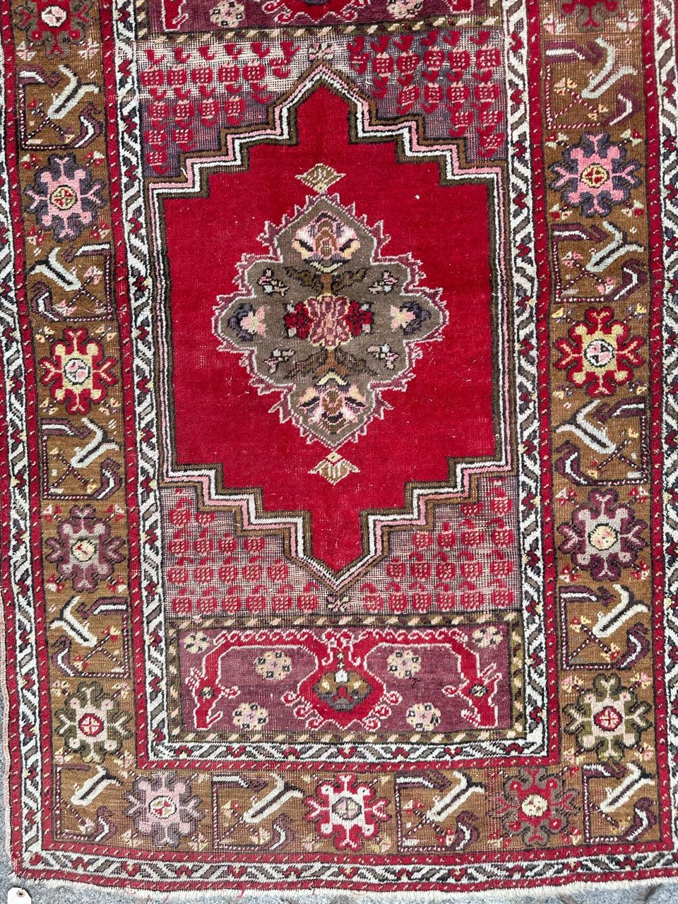 Bel tappeto turco di metà secolo con un bel disegno geometrico con un medaglione centrale e disegni stilizzati, e bei colori con rosso, viola, verde, giallo, rosa, marrone e bianco, interamente annodato a mano con lana su base di lana.
Usura dovuta