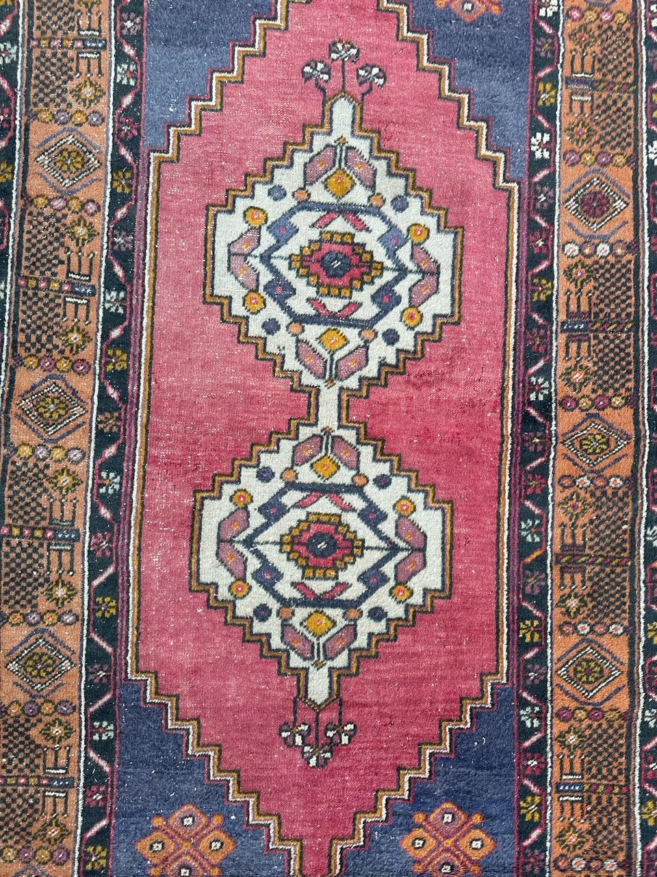 Nice mid century Turkish rug with nice geometrical design with two central medallions and stylized designs, and nice colours with pink , purple, yellow, black and white, entirely hand knotted with wool on wool foundation.
Wears due to the age and